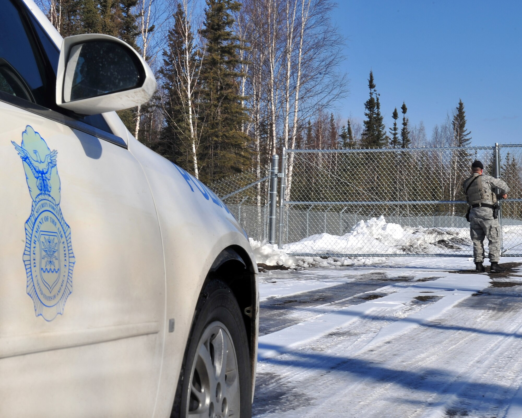 Staff Sgt. Cody Belt, 354th Security Forces Squadron delta flight sergeant, ensures a perimeter gate on Eielson Air Force Base is secure April 6, 2009. Security Forces have various checks that must be accomplished daily both on-base and along the Richardson Highway. (U.S. Air Force photo/Airman 1st Class Willard E. Grande II)