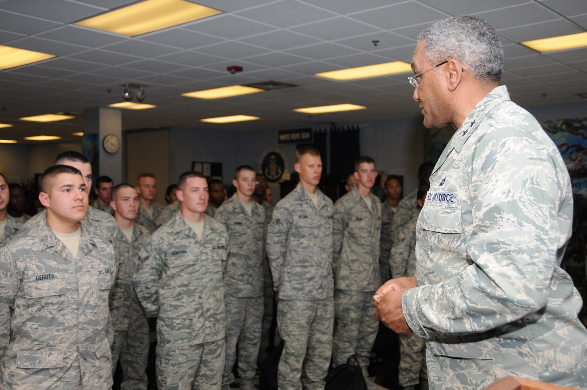 Airman Basic James Gerdts, left, 334th Training Squadron, along with Airman Kwasi Appiah, 335th TRS, and Airman Basic Andrea Iverson, 336th TRS, were coined by Maj. Gen. Alfred Flowers, 2nd Air Force commander, right, March 30.  General Flowers commended the students for the professionalism during the chiefs’ induction ceremony March 27.   (U.S,. Air Force photo by Kemberly Groue)