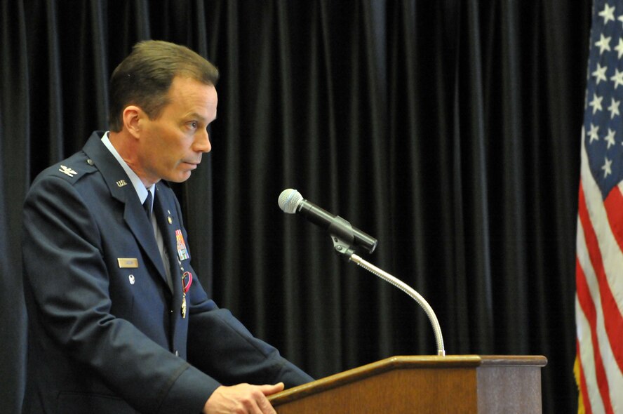 Col. Andrew R. "Hoops" Larson speaks to friends and family at his retirement ceremony at Club Hill Apr. 5. 