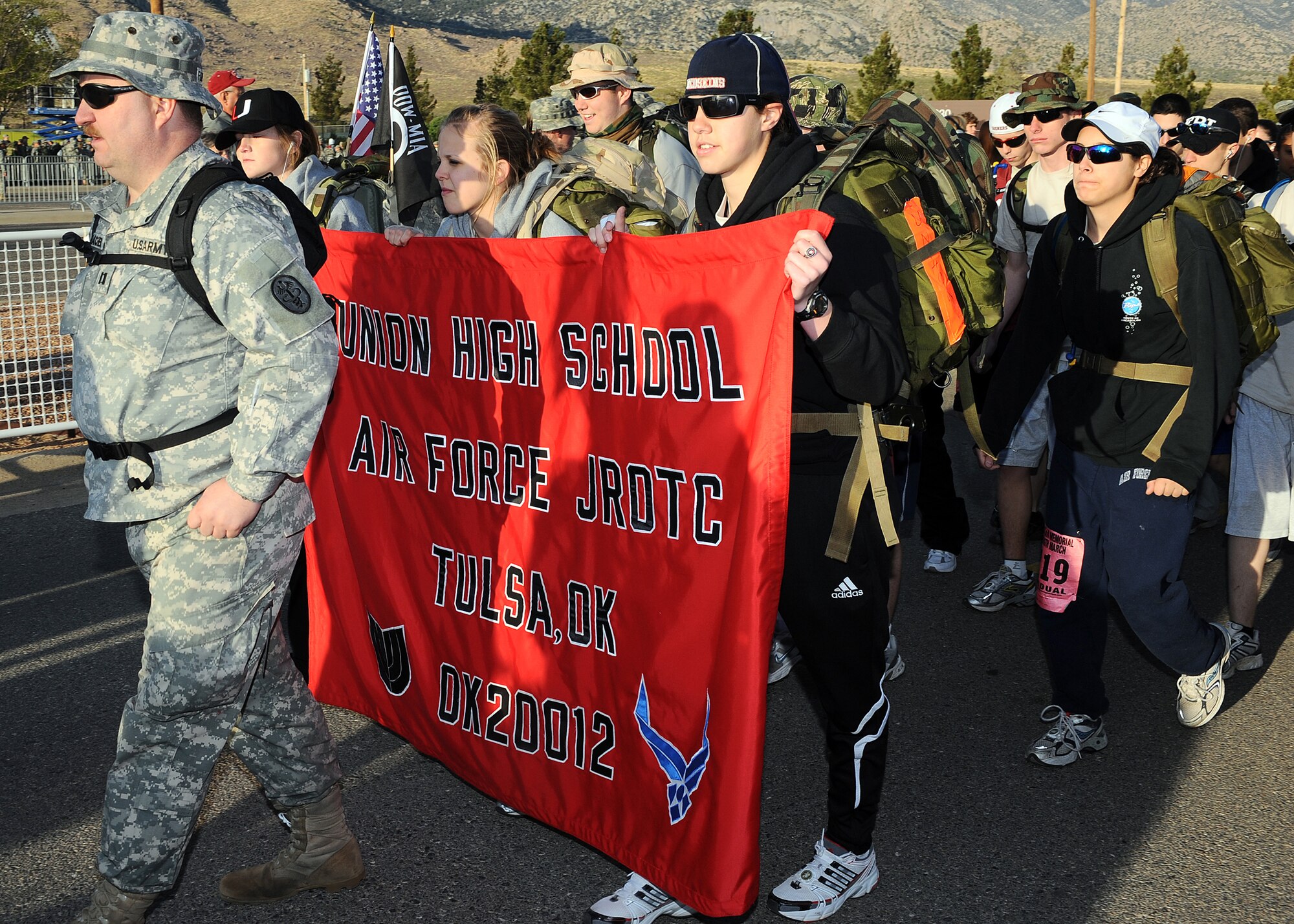 Participants from Union High School JROTC from Tulsa, Okla, show thier bannar proudly at the 20th Annual Bataan Memorial Death March at White Sands Missle Range, N.M., March 29. The march honors a special group of World War II heroes who were responsible for the defense of the islands of Luzon, Corregidor and the harbor defense forts of the Philippines. (U.S. Air Force photo/ Airman 1st Class DeAndre Curtiss)