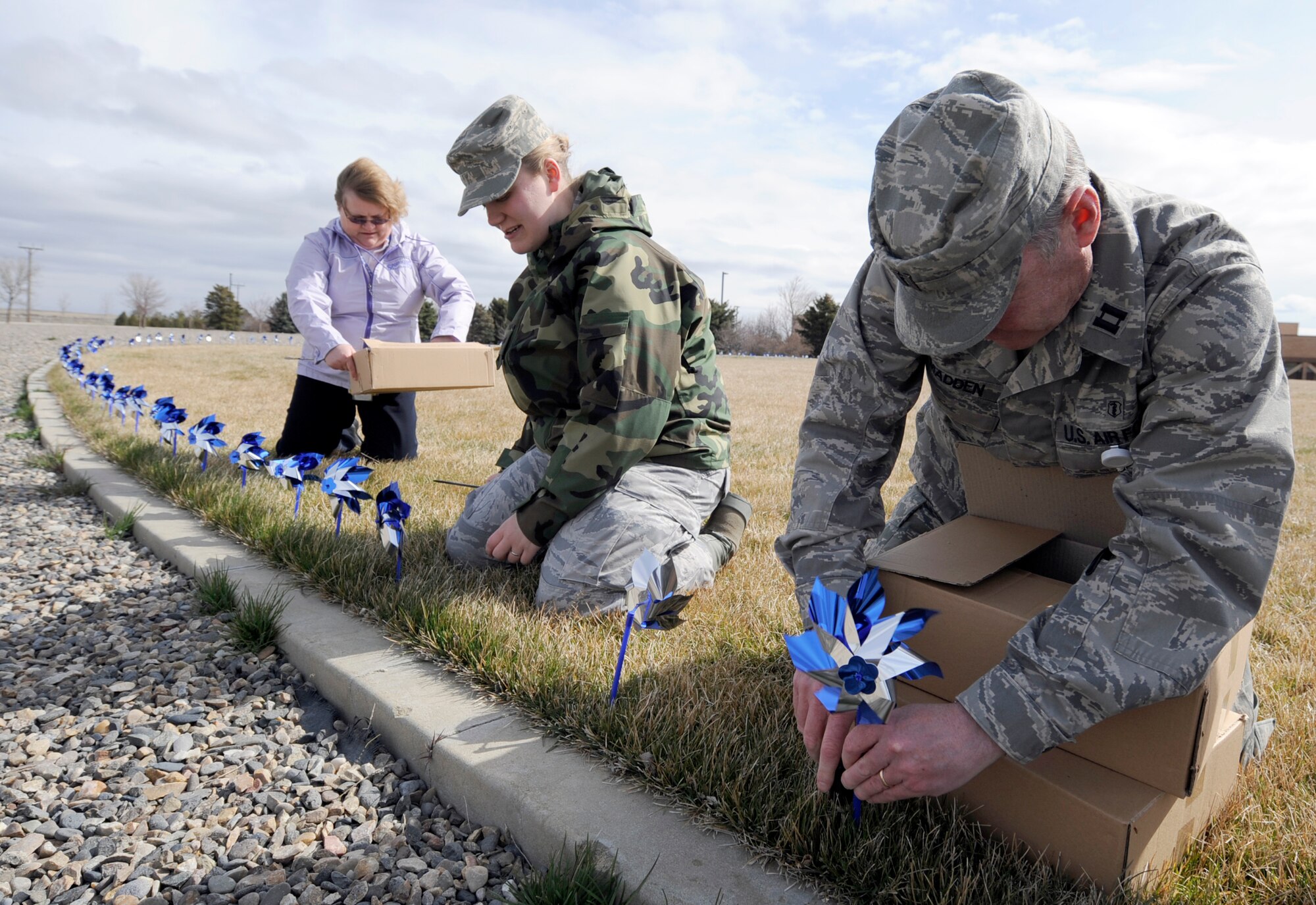 MOUNTAIN HOME AIR FORCE BASE, Idaho – Capt. Thomas Madden, 366th Medical Operations Squadron, helps “plant” one of the 209 blue and silver pinwheels at the base hospital. Each pinwheel, one for each child born on base in 2008, is used to raise awareness and educate families about Child Abuse Prevention Awareness Month. (U.S. Air Force photo\ Senior Airman Stephany Miller)