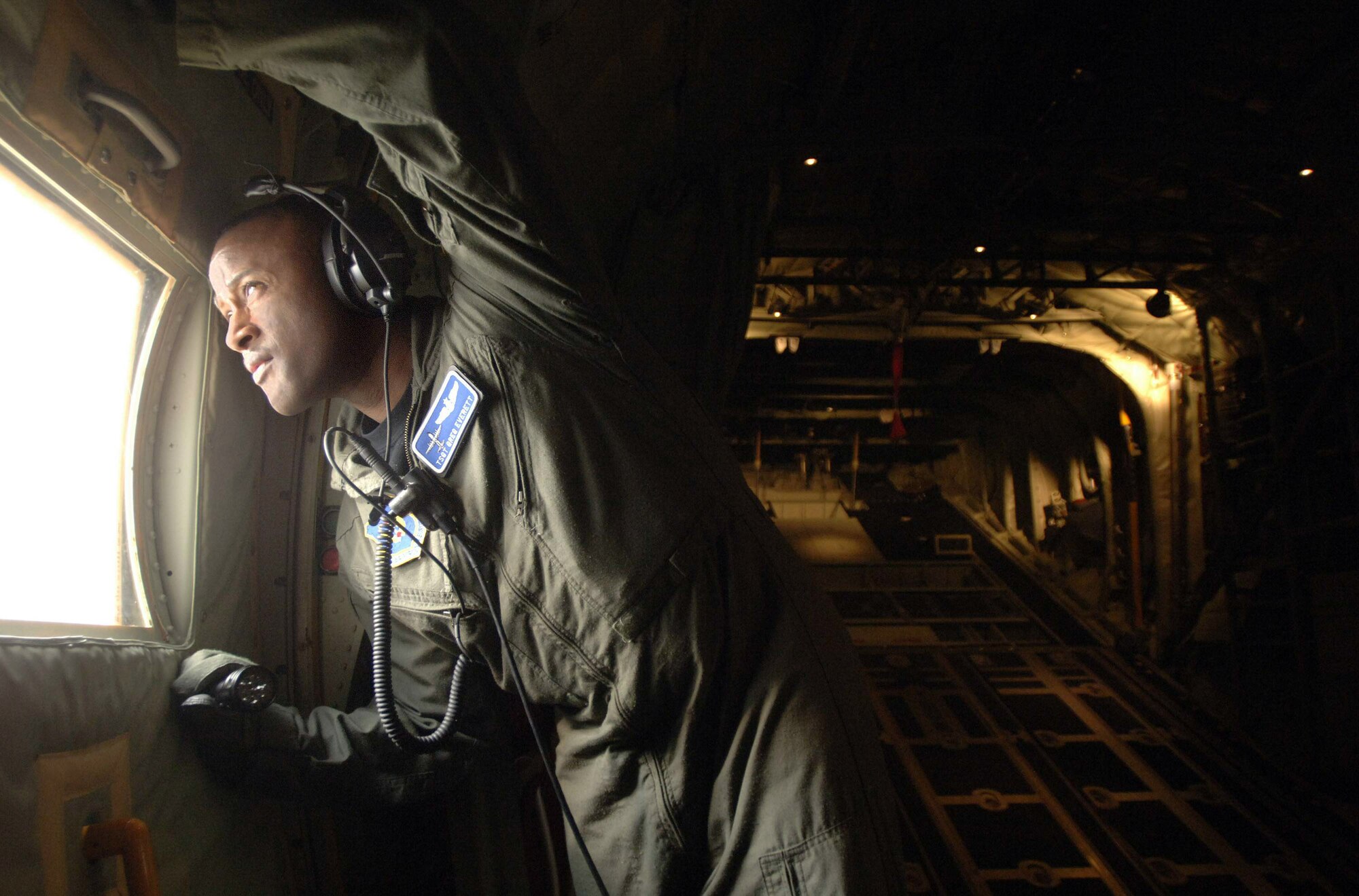 Minutes after departure from Spangdahlem Air Base, Germany, Tech. Sgt. Greg Everett, a C-130J Super Hercules loadmaster, performs a visual inspection of the wings and engines of a new J-model with fewer than 24 hrs of logged flight time. The aircraft was completing the last leg of its trans-Atlantic journey from the aircraft assembly plant in Marietta, Ga. to its new home station at Ramstein AB, Germany. . This J-model is the first of 14 aircraft that are scheduled to arrive at Ramstein over the next 12 months to replace the older E-models there.  (Defense Department photo/Master Sgt. Scott Wagers)