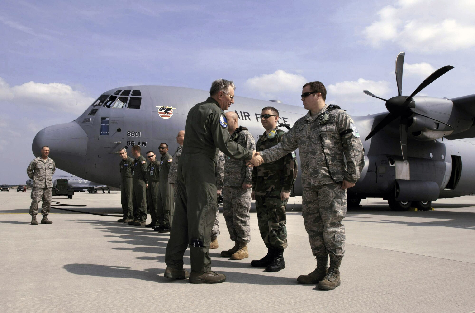 Prior to flying the C-130J Super Hercules sitting on the ramp at Spangdahlem Air Base, Germany, on the last leg of its trans-Atlantic journey from the aircraft assembly plant in Marietta, Ga., to its new home at Ramstein AB, Germany, Gen. Roger A. Brady, U.S. Air Forces in Europe commander, greets Staff Sgt. William Lau and fellow C-130J aircraft maintainers, pilots and load masters.  General Brady flew the J-model from Spangdahlem to Ramstein.  (Defense Department photo/Master Sgt. Scott Wagers)