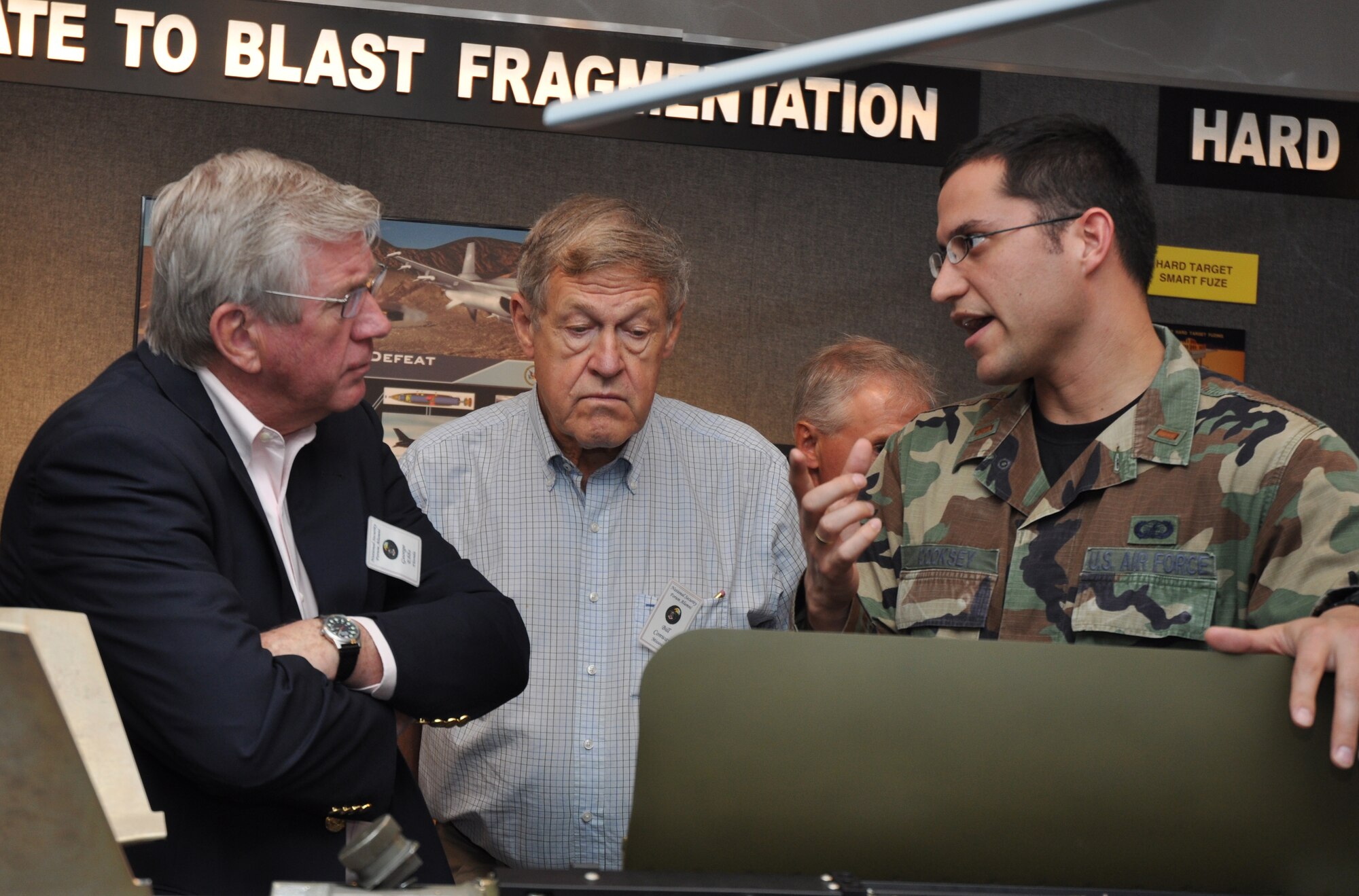 EGLIN AIR FORCE BASE, Fla. – Second Lieutenant Mitcheal Cooksey, Air Force Research Laboratory, shows, National Security Forum alumni models of weapons developed and tested on Eglin.  The National Security Forum, hosted by the Air War College at Maxwell Air Force Base, Ala., exposes influential community leaders to senior national and international officers and civilians to gain insight into the Air Force as well as national and international security issues. (U.S. Air Force Photo/Jasmine DeNamur)