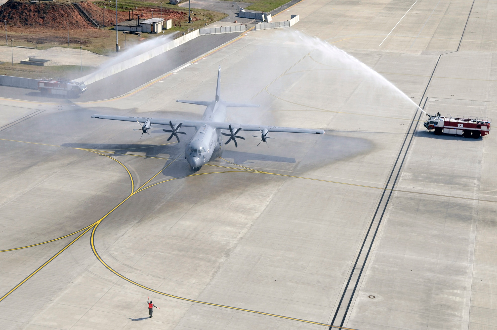 A C-130J Super Hercules taxis through water April 7 on the flightline of Ramstein Air Base, Germany, after landing at the base for the first time.  The J-model arrived during a ceremony that heralded a new era in operations for the 86th Airlift Wing. This aircraft is the first of 14 J-models that are scheduled to arrive over the next 12 months to replace the older E-model Hercules stationed there.  (U.S. Air Force photo/Staff Sgt. Stephen J. Otero)