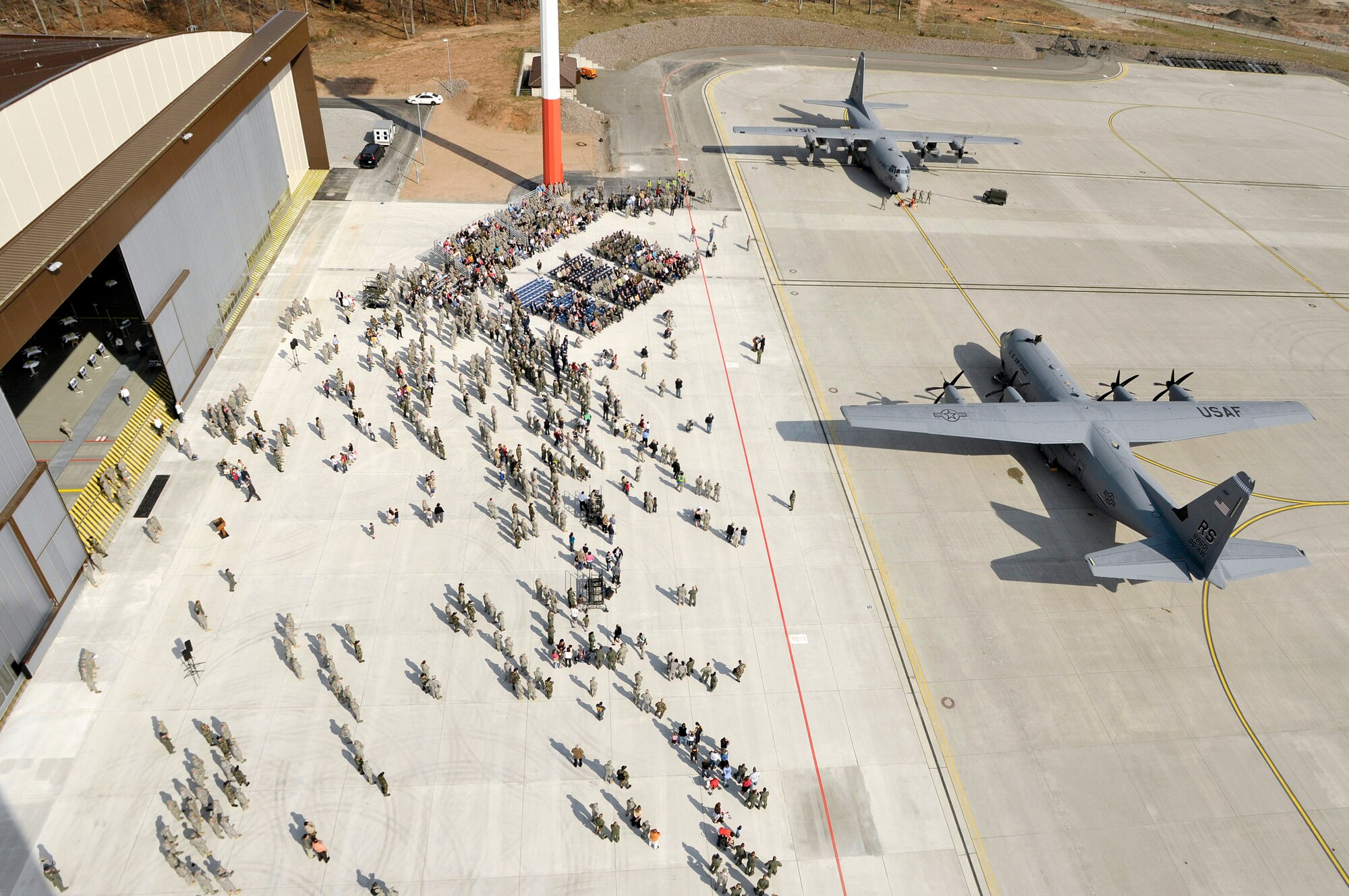 A C-130J Super Hercules (front) and C-130E Hercules sit on the flightline at Ramstein Air Base, Germany, April 7.   The J-model arrived during a ceremony that heralded a new era in operations for the 86th Airlift Wing there. The J-model is the first of 14 aircraft that are scheduled to arrive over the next 12 months to replace the older E-models.  (U.S. Air Force photo/Staff Sgt. Stephen J. Otero)
