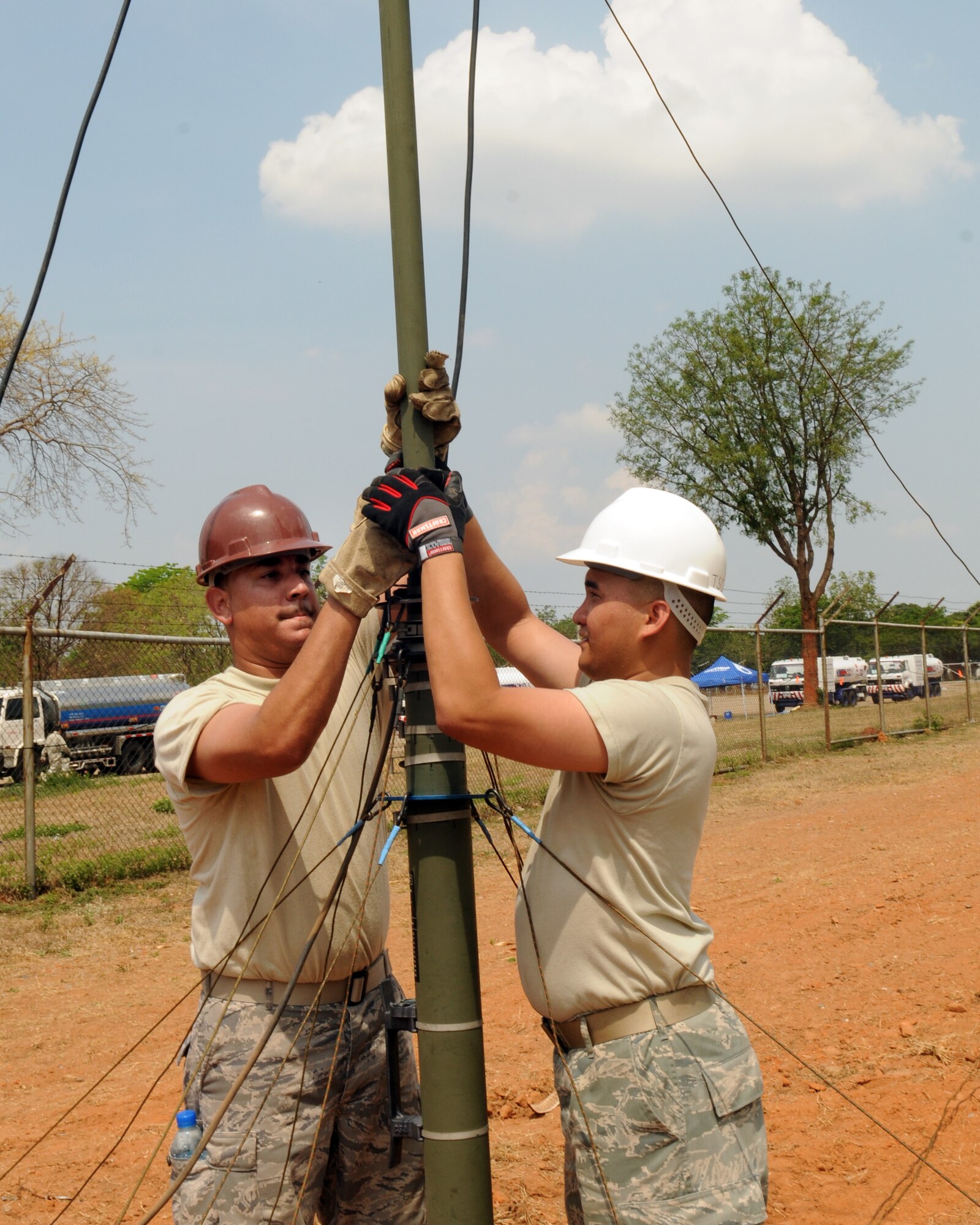 Tech. Sgt. Joe Laurent, a transmissions systems technician, and Staff Sgt. Jason Ing, a Data Links Technician, both from the 56th Air and Space Communications Squadron, Hickam Air Force Base, Hawaii, set up an antenna for air-to-ground communications during Cope Tiger 2009, March 12. 

Cope Tiger 2009 is an annual exercise to improve combat readiness and combined and joint interoperability for U.S., Thai and Singaporean forces while enhancing regional security and providing humanitarian support. (U.S. Air Force Photo/Staff Sgt. Angelique Perez)