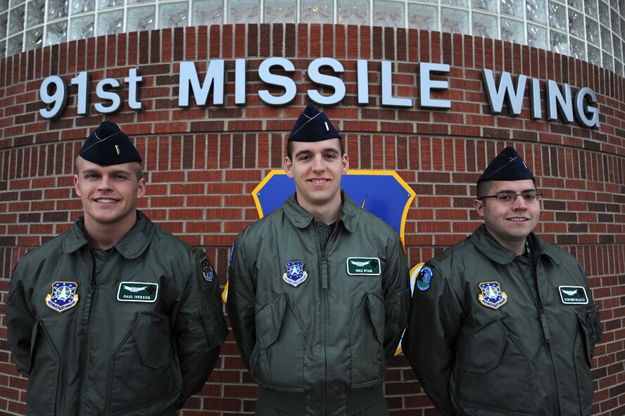 MINOT AIR FORCE BASE, N.D. – Deputy missile combat crew commanders from the 741st Missile Squadron stand in front of the 91st Missile Wing headquarters building, after performing reveille here, April 3. 91st MW squadrons began performing reveille as part of Col. Christopher Ayres, 91st MW commander's plan for the 'Return to Glory'. This battle cry embodies what Colonel Ayres wishes to instill in all his fellow Airmen; honor, respect and pride in everything they do. The time-honored tradition of reveille is performed every Friday morning at 7:30 a.m., and will continue until the fall. (U.S. Air Force photo by Senior Airman Kelly Timney)