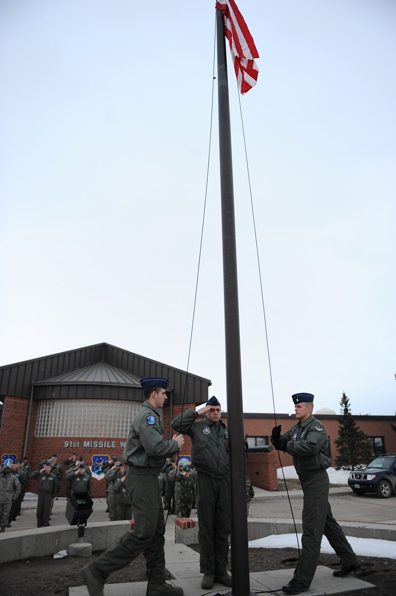 MINOT AIR FORCE BASE, N.D. – 2nd Lt. Stephen Milacci, a 741st Missile Squadron deputy missile combat crew commander, salutes the American flag after the playing of “To the Colors”, in front of the 91st Missile Wing headquarters building here, April 3. 91st MW squadrons began performing reveille as part of Col. Christopher Ayres, 91st MW commander's plan for the 'Return to Glory'. This battle cry embodies what Colonel Ayres wishes to instill in all his fellow Airmen; honor, respect and pride in everything they do. The time-honored tradition of reveille is performed every Friday morning at 7:30 a.m., and will continue until the fall. (U.S. Air Force photo by Senior Airman Kelly Timney)