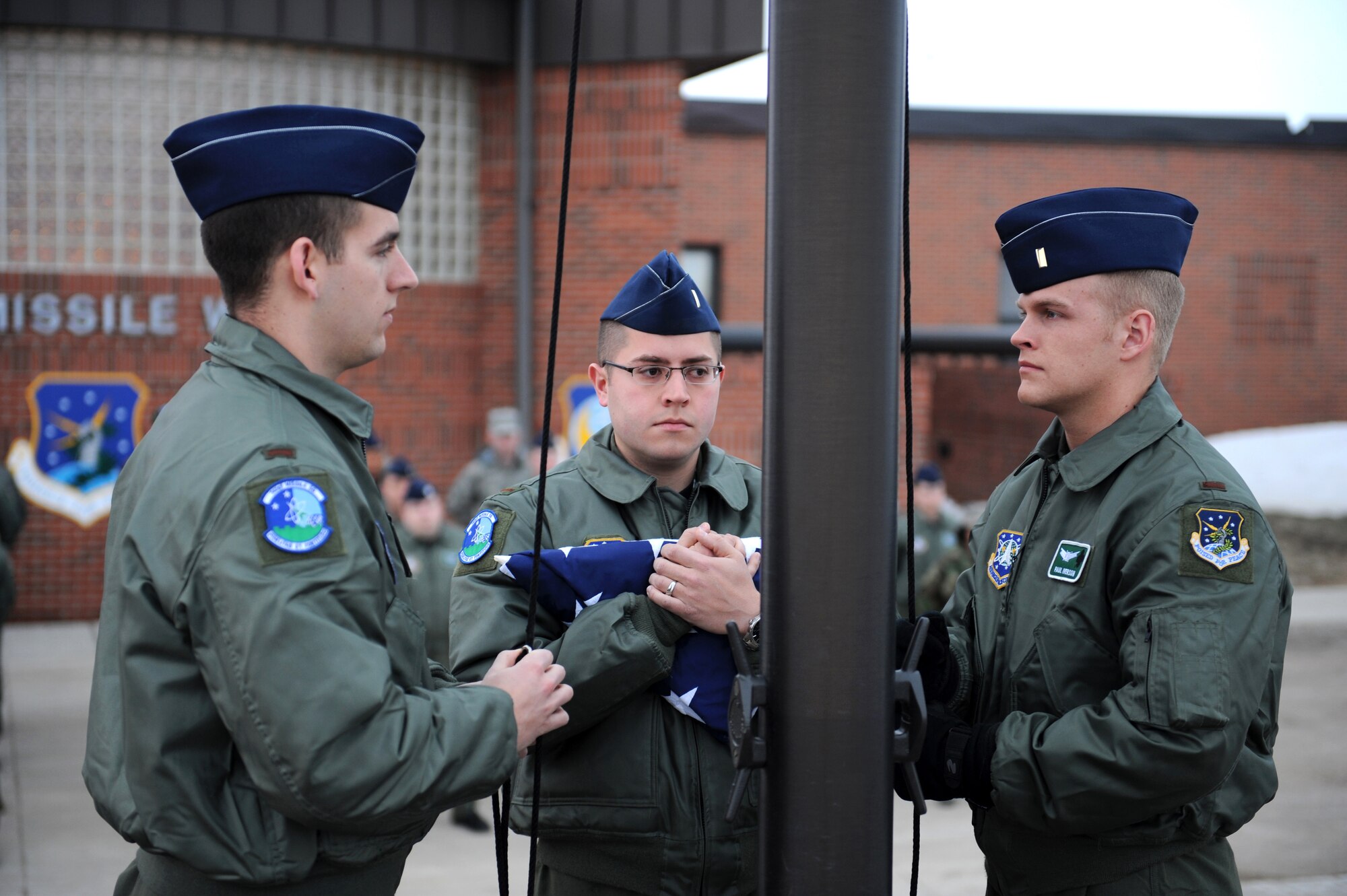 MINOT AIR FORCE BASE, N.D. -- Airmen from the 741st Missile Squadron welcome the beginning of spring by performing reveille at the 91st Missile Wing headquarters building here April 3. 91st MW squadrons began performing reveille as part of Col. Christopher Ayres, 91st MW commander's plan for the "Return to Glory". This battle cry embodies what Colonel Ayres wishes to instill in all his fellow Airmen; honor, respect and pride in everything they do. The time-honored tradition of reveille is performed every Friday morning at 7:30 a.m., and will continue until the fall. (U.S. Air Force photo by Senior Airman Kelly Timney)