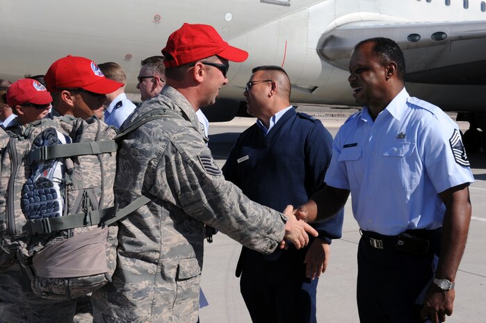 Chief Master Sgt. Ronald Brown, a chief enlisted manager with the 99th Civil Engineering Squadron, and Chaplain (Capt.) Craig Nakagawa, a Chaplain with the 99 Air Base Wing, greet more than 300 Airmen from the 820th RED HORSE upon their arrival home after a seven-month deployment in Southwest Asia, April 6, Nellis Air Force Base, Nev. RED HORSE squadrons provide the Air Force with a highly-mobile civil engineering capability in support of the contingency and special operations worldwide.(U.S. Air Force photo by Airman 1st Class Brett Clashman/Released)

