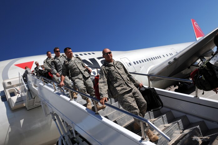 Nellis Airmen from the 820th RED HORSE Squadron return home from the aircraft on the Nellis flightline after a seven-month deployment in Southwest Asia, April 6, Nellis Air Force Base, Nev. RED HORSE squadrons provide the Air Force with a highly-mobile civil engineering capability in support of the contingency and special operations worldwide.(U.S. Air Force photo by Airman 1st Class Brett Clashman/Released)