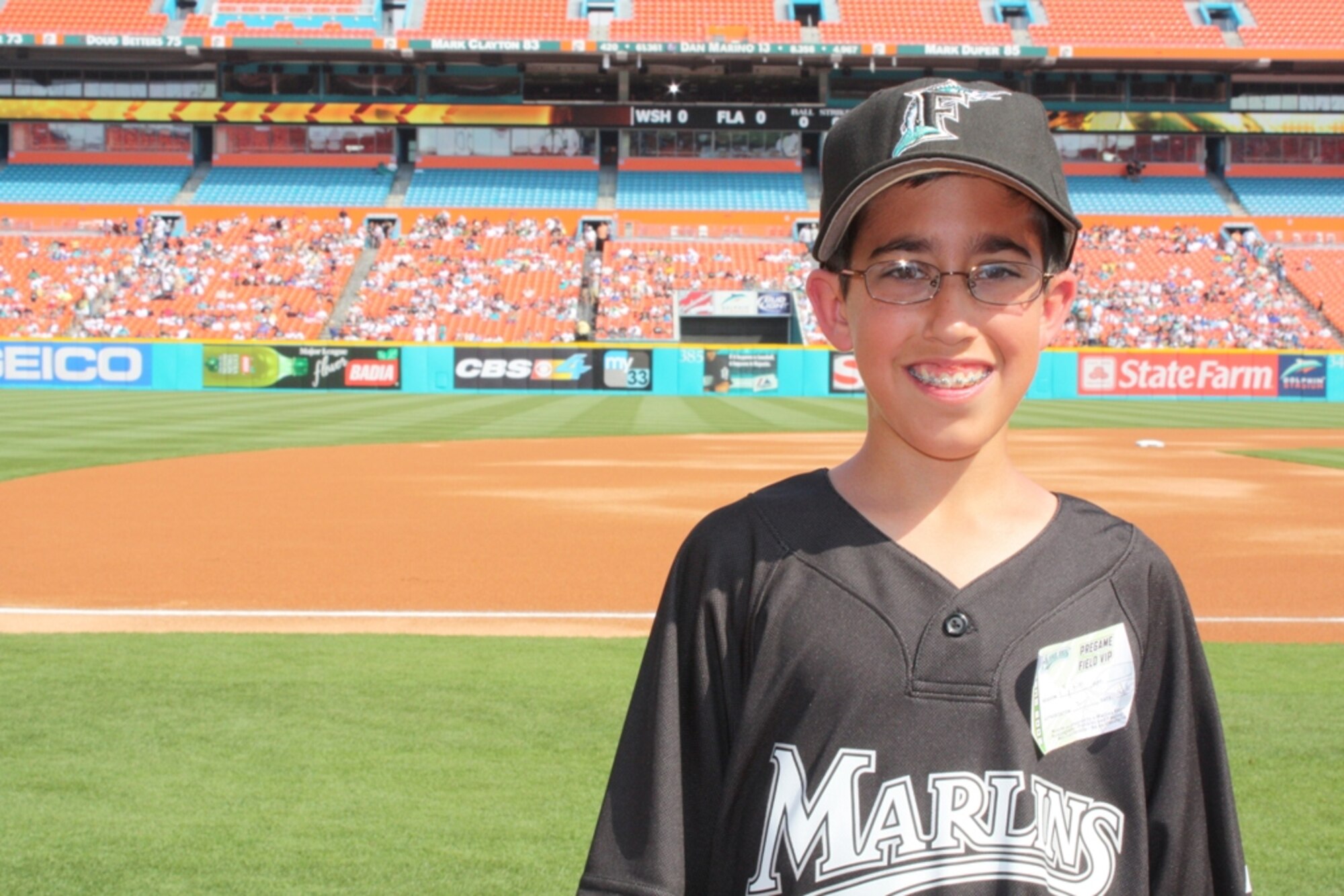Sean Romero waits for his chance throw the first pitch of the Florida Marlins 2009 season in front of 33,000 fans at Dolphin Stadium on April 6. Sean Romero’s father, Senior Master Sgt. Tony Romero is the life support NCO-in-charge from the 93rd Fighter Squadron and is currently deployed to Joint Base Balad, Iraq. Sergeant Romero was filmed giving a “shout-out” to Marlins fans and asking Sean to help him out with the opening pitch for the Marlins’ pre-game tribute to the military. (U.S. Air Force photo/2nd Lt Erik Hofmeyer)