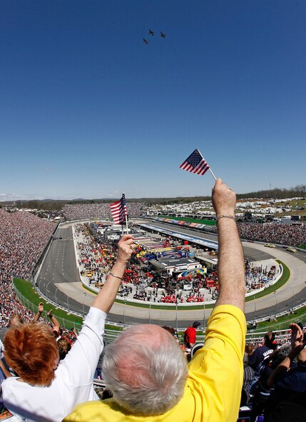 LAUGHLIN AIR FORCE BASE, Texas--Three T-38C's from Laughlin's 87th Flying Training Squadron fly over the stadium at the Goody's Fast Pain Relief 500 NASCAR Race in Martinsville, Va., while fans wave American flags at the last note of the National Anthem March 29.  Captains Joe Goldsworthy and Aaron Brown flew in the lead jet, while Captains Jeffrey Hedgpeth, Jeremiah Guild and Siegfried Jucknies flew in the wing aircraft.  (Courtesy photo)        