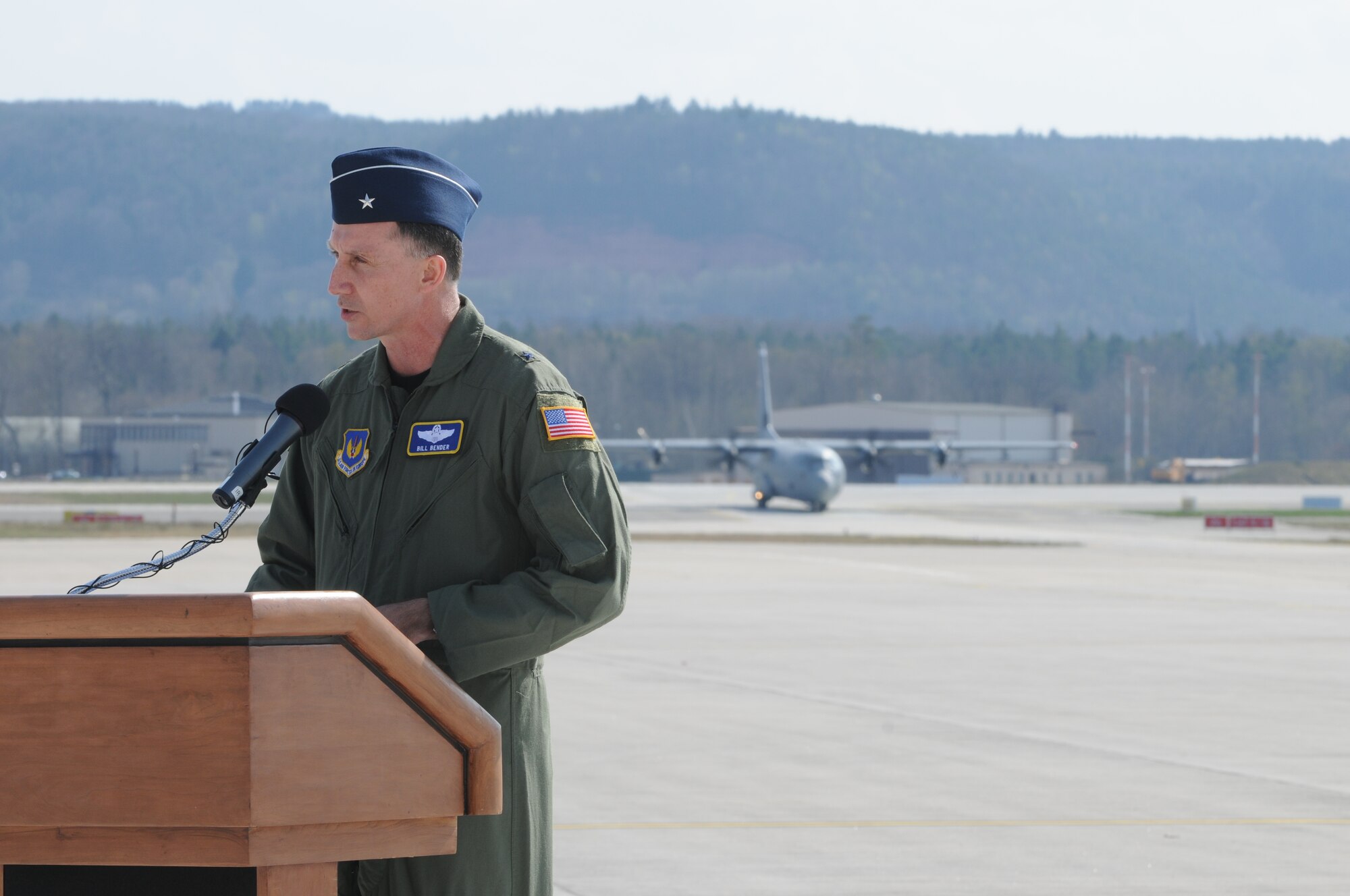 Brig. Gen. Bill Bender, 86th Airlift Wing commander, speaks while a C-130J landson Ramstein Air Base for the first time during a ceremony April 7. The ceremony also included a ribbon cutting for a new 68,000 square feet dual-bay maintenance hangar, which can hold two C-130J aircraft or one C-17. (U.S. Air Force photo by Senior Airman Levi Riendeau)
