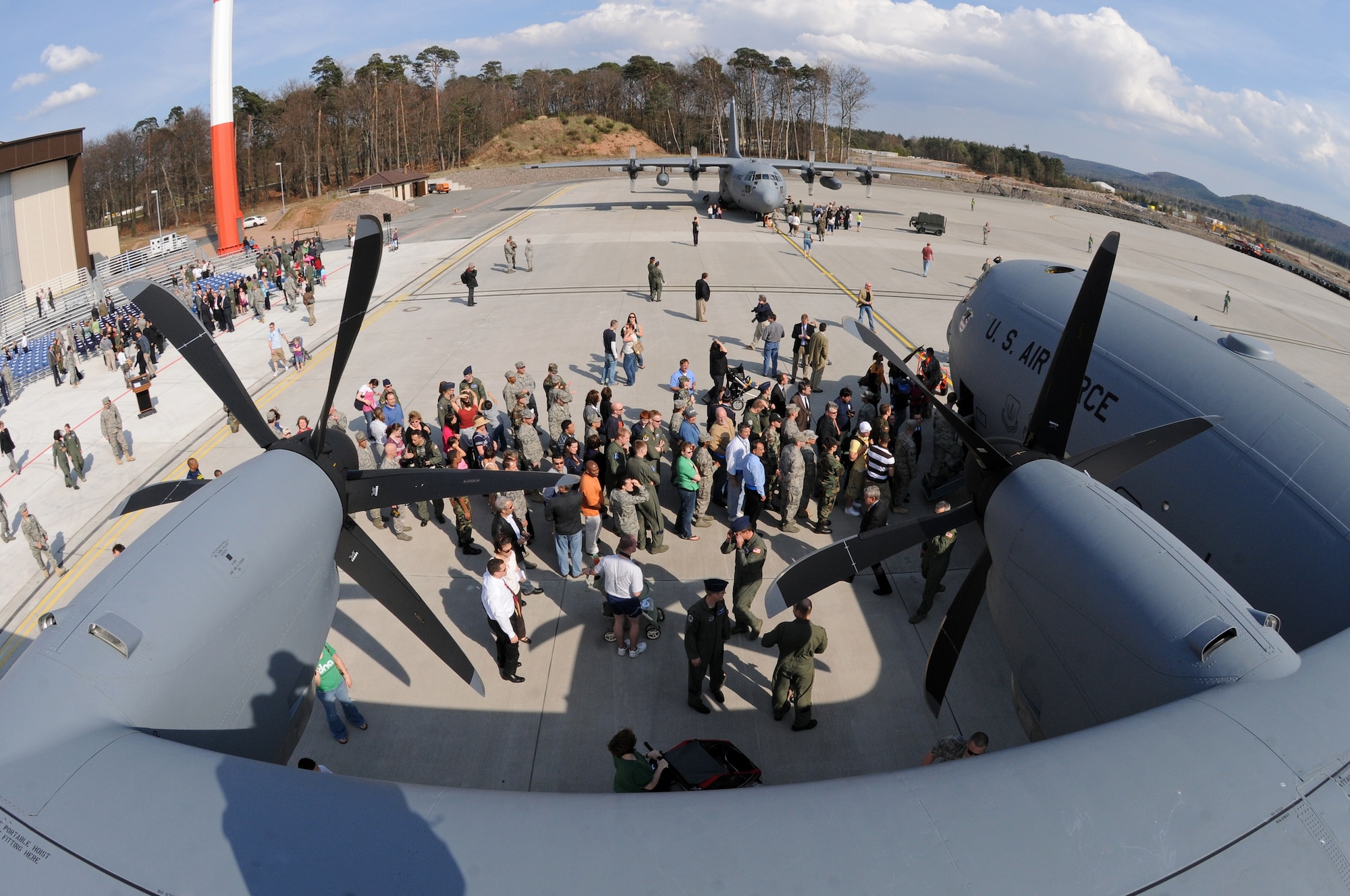 Members from all over the Kaiserslautern Military Community wait to take a tour of Ramstein Air Base's newest aircraft, a C-130J, during a celebration ceremony held April 7. The J-model landed on Ramstein for the first time during a ceremony today held to not only honor the arrival of the new aircraft, but also a new era in operations for the 86th Airlift Wing. The ceremony also included a ribbon cutting for a new 68,000 square feet dual-bay maintenance hangar, which can hold two C-130J aircraft or one C-17.  (U.S. Air Force photo by Airman 1st Class Grovert Fuentes-Contreras)