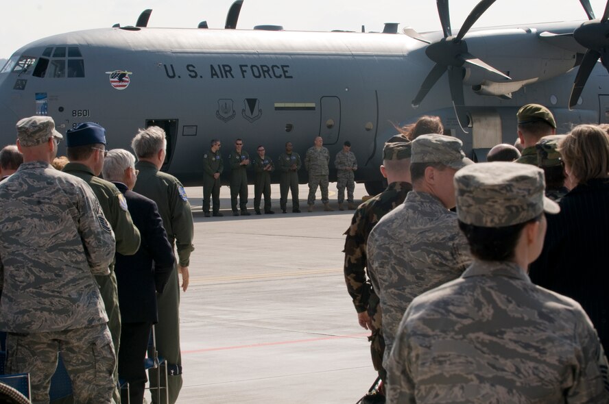 Team Ramstein members await the opportunity to tour the 86th Airlift Wing's newest aicraft, a C-130J, after it makes a historic landing on Ramstein Air Base April 7. A ceremony was held to not only honor the arrival of the new aircraft, but also a new era in operations for the 86th AW. The ceremony also included a ribbon cutting for a new 68,000 square feet dual-bay maintenance hangar, which can hold two C-130J aircraft or one C-17. (U.S. Air Force photo by Senior Airman Nathan Lipscomb)