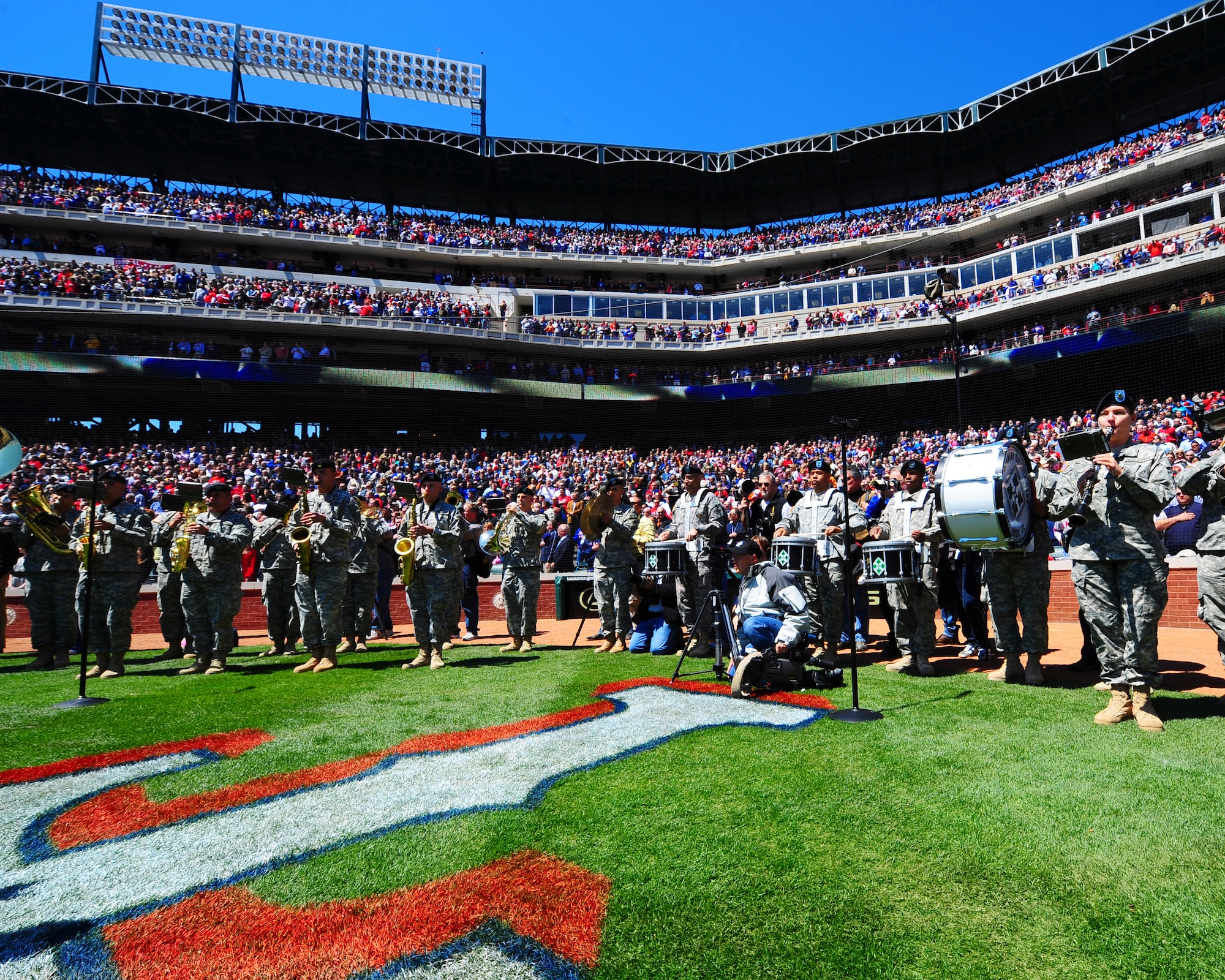 ARLINGTON, Texas - Members of the Fourth Infantry Division Band perform the National Anthem here Monday April 6.  The Band was included in the opening ceremonies at the ballpark, during which many U.S. military personel were honored. (U.S. Air Force photo by Staff Sgt Alan Garrison)