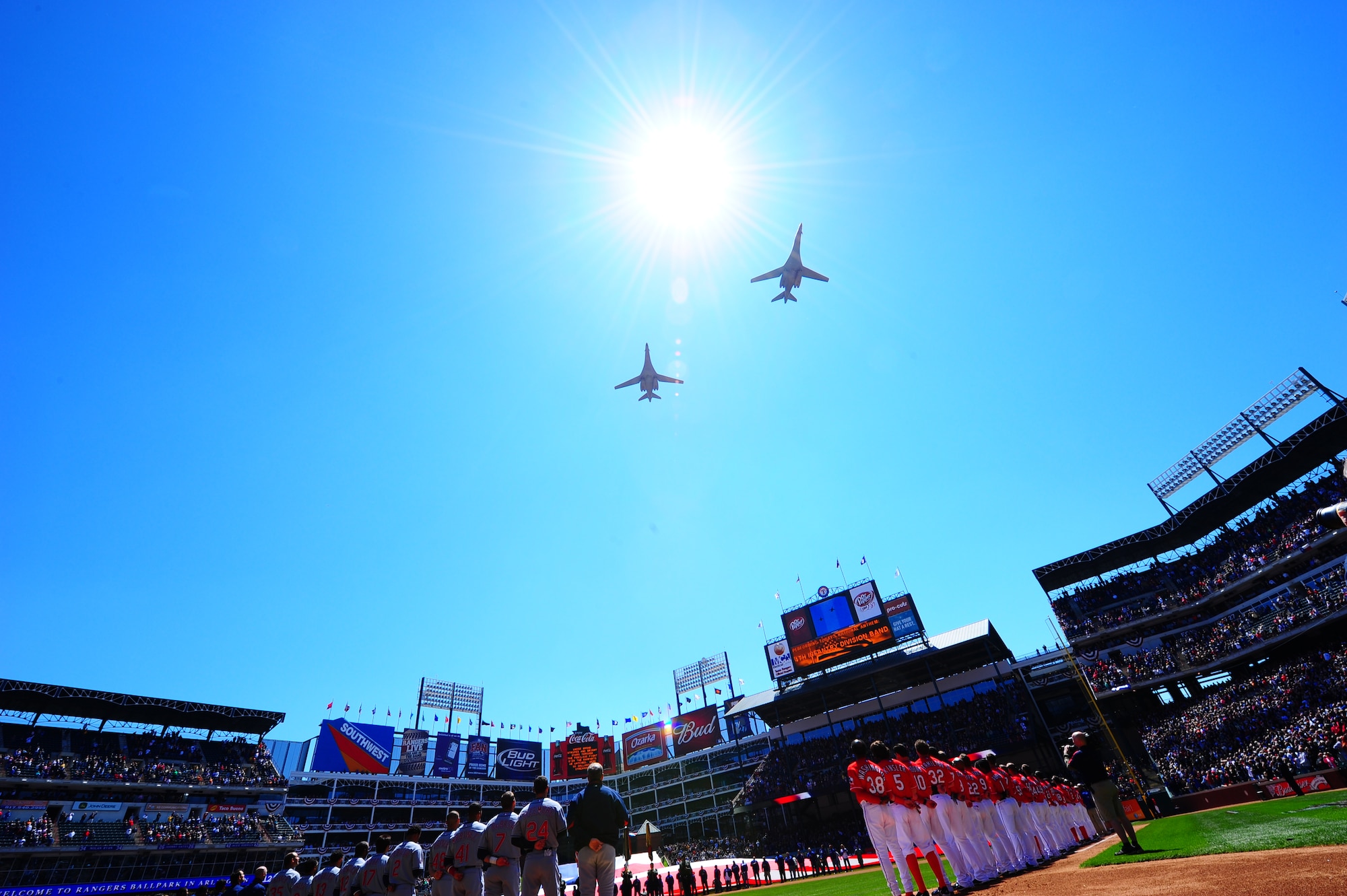 ARLINGTON, Texas - Two B-1 Bombers perform a flyover during the National Anthem for opening day here Monday April 6.  The two Air Force bombers are from the 9th Bomb Squadron at Dyess, Air Force Base, Texas. They  were part of the opening ceremonies in which many military personell were honored. (U.S. Air Force photo by Staff Sgt Alan Garrison)
