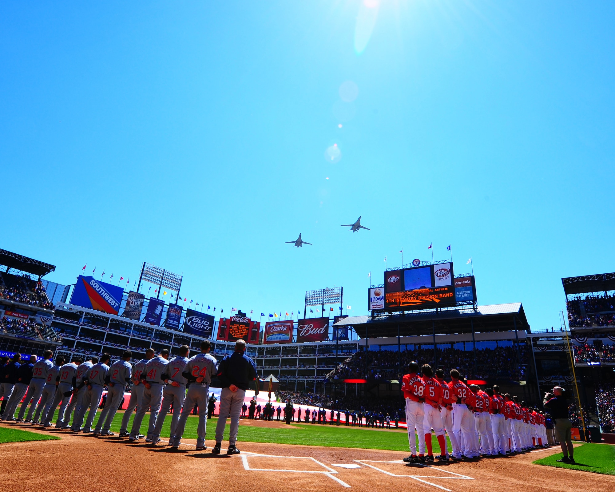 ARLINGTON, Texas - Two B-1 bombers perform a flyover during the National Anthem for opening day here Monday April 6.  The two Air Force bombers are from the 9th Bomb Squadron at Dyess, Air Force Base, Texas. They  were part of the opening ceremonies in which many military personell were honored. (U.S. Air Force photo by Staff Sgt Alan Garrison)