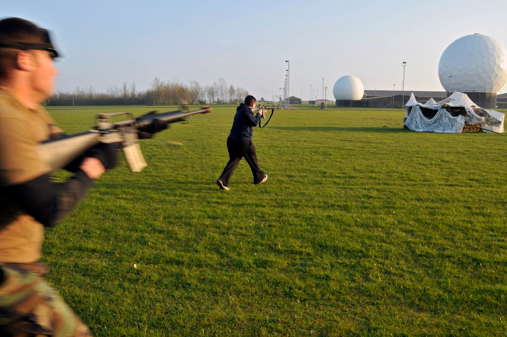 ROYAL AIR FORCE FELTWELL, England -- Simulated opposing force members attack a defensive fighting position here April 2, 2009. Airmen from the 48th SFS participated in an air base defense exercise. The training is an annual requirement for the squadron. (U.S. Air Force photo by Airman 1st Class Perry Aston) (Released)