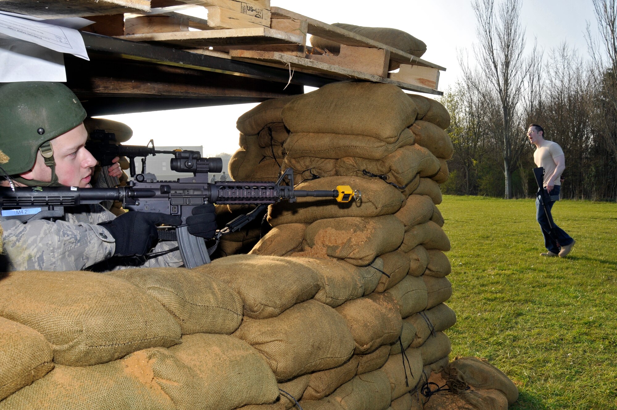 ROYAL AIR FORCE FELTWELL, England -- Airman 1st Class Andrew Middleton, 48th Security Forces Squadron watches his field of fire while a member of the opposing force advance on his defensive fighting position here April 2, 2009. Airmen from the 48th SFS participated in an air base defense exercise. The training is an annual requirement for the squadron. (U.S. Air Force photo by Airman 1st Class Perry Aston) (Released)