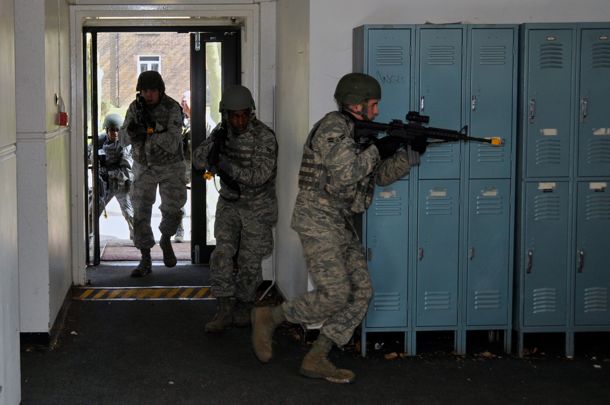 ROYAL AIR FORCE FELTWELL, England -- 48th Security Forces Squadron Airmen storm a building suspected of being occupied by members of an opposing force here April 2, 2009. Airmen from the 48th SFS participated in an air base defense exercise. The training is an annual requirement for the squadron. (U.S. Air Force photo by Airman 1st Class Perry Aston) (Released)