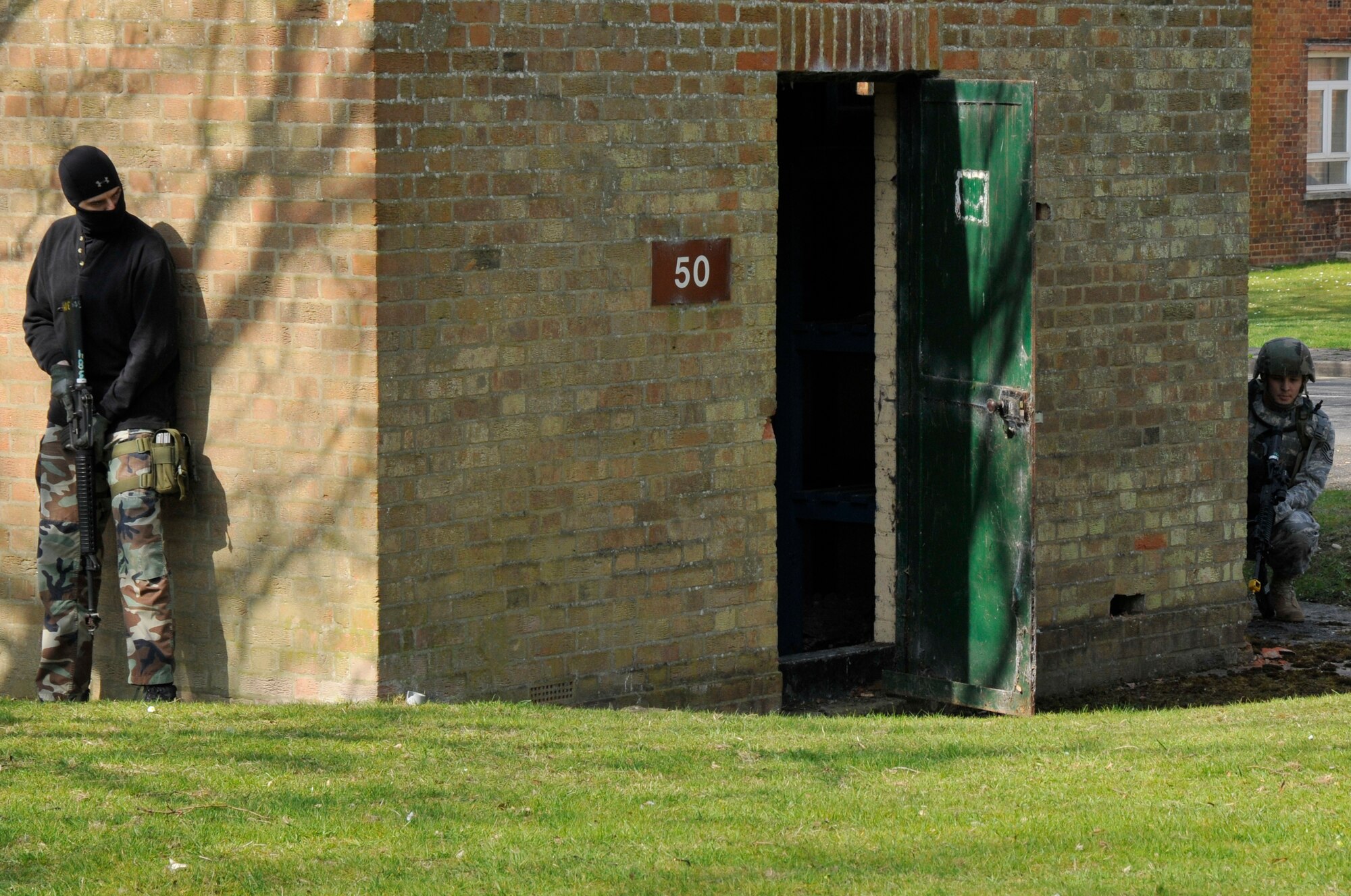 ROYAL AIR FORCE FELTWELL, England -- A simulated opposing force member stands ready for 48th Security Forces personnel to advance toward his position here April 2, 2009. Airmen from the 48th SFS participated in an air base defense exercise. The training is an annual requirement for the squadron. (U.S. Air Force photo by Airman 1st Class Perry Aston) (Released)