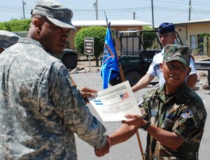 SOTO CANO AIR BASE, Honduras - Maj. Toihunta Stubbs, Joint Task Force-Bravo Medical Element flight surgeon, stops for a picture with Sgt. José Marroquin of the Honduran Air Force, during graduation from JTF-B's combat lifesafer course Friday.  Thirty Honduran Air Force cadets and airmen graduated the course taught by instructors from MEDEL.  During the weeklong course, students learned self-aid and buddy care, how to administer intravenous fluids, and medical evacuation.  (U.S. Air Force photo/Tech. Sgt. Rebecca Danét)