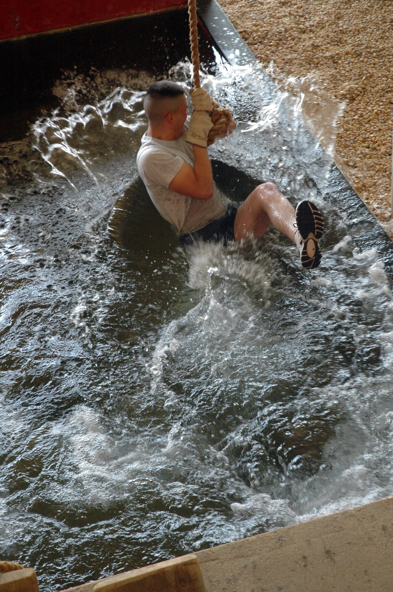 Airman 1st Class Michael Courtright falls in the water on an obstacle during a leadership reaction course March 30 at Maxwell Air Force Base, Ala. The traveling component of the Air Force Honor Guard, the drill team serves as Air Force ambassadors to recruit, retain and inspire Airmen around the globe. Airman Courtright is an Air Force Honor Guard drill team member. (U.S. Air Force photo/Senior Airman R. Michael Longoria) 
