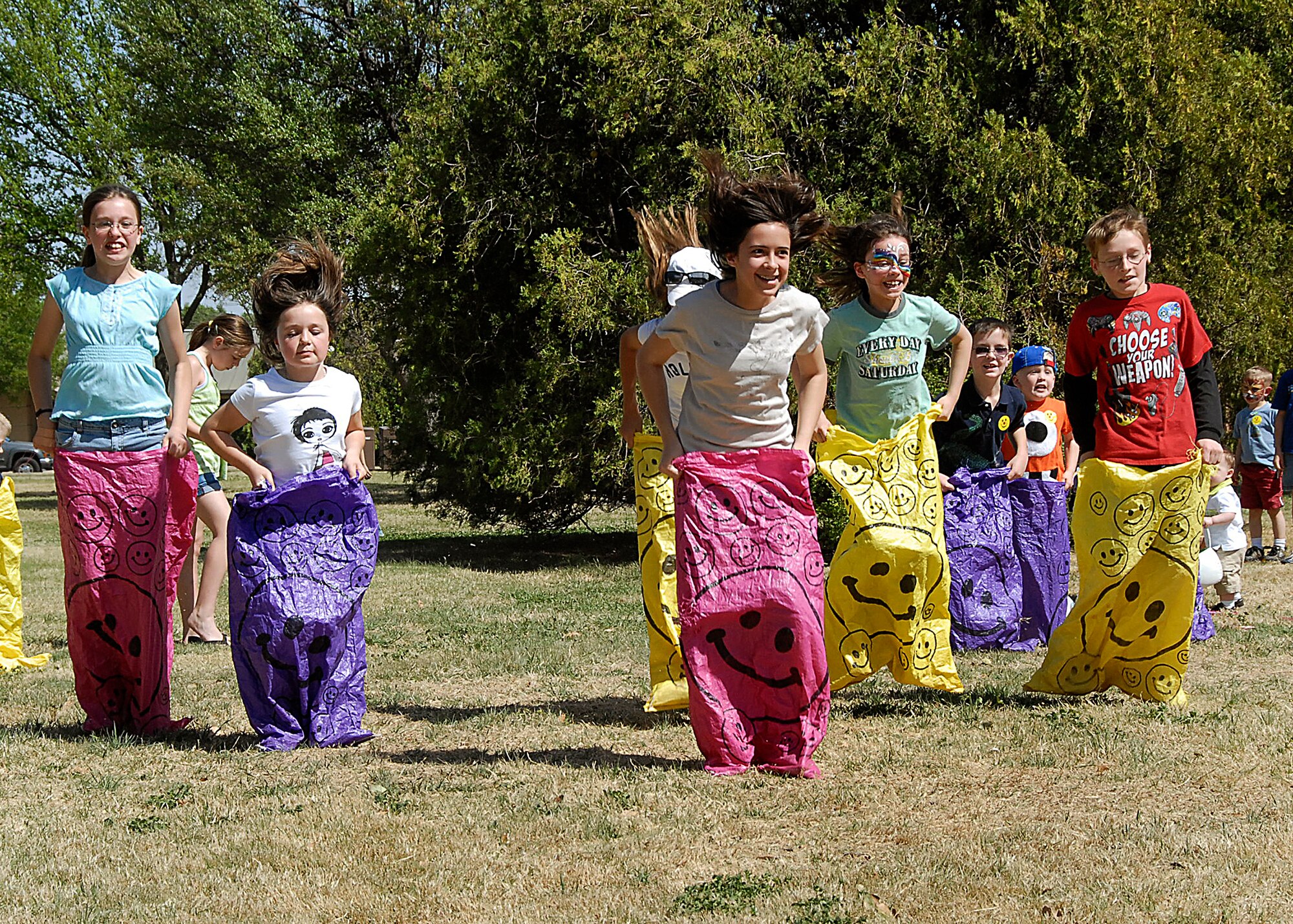 Children of the 80th Flying Training Wing members compete in a potato sack race April 4 at the South Chapel Pavilion. The wing hosted its annual Easter party, providing fun-filled activities. (U.S. Air Force photo/Harry Tonemah)