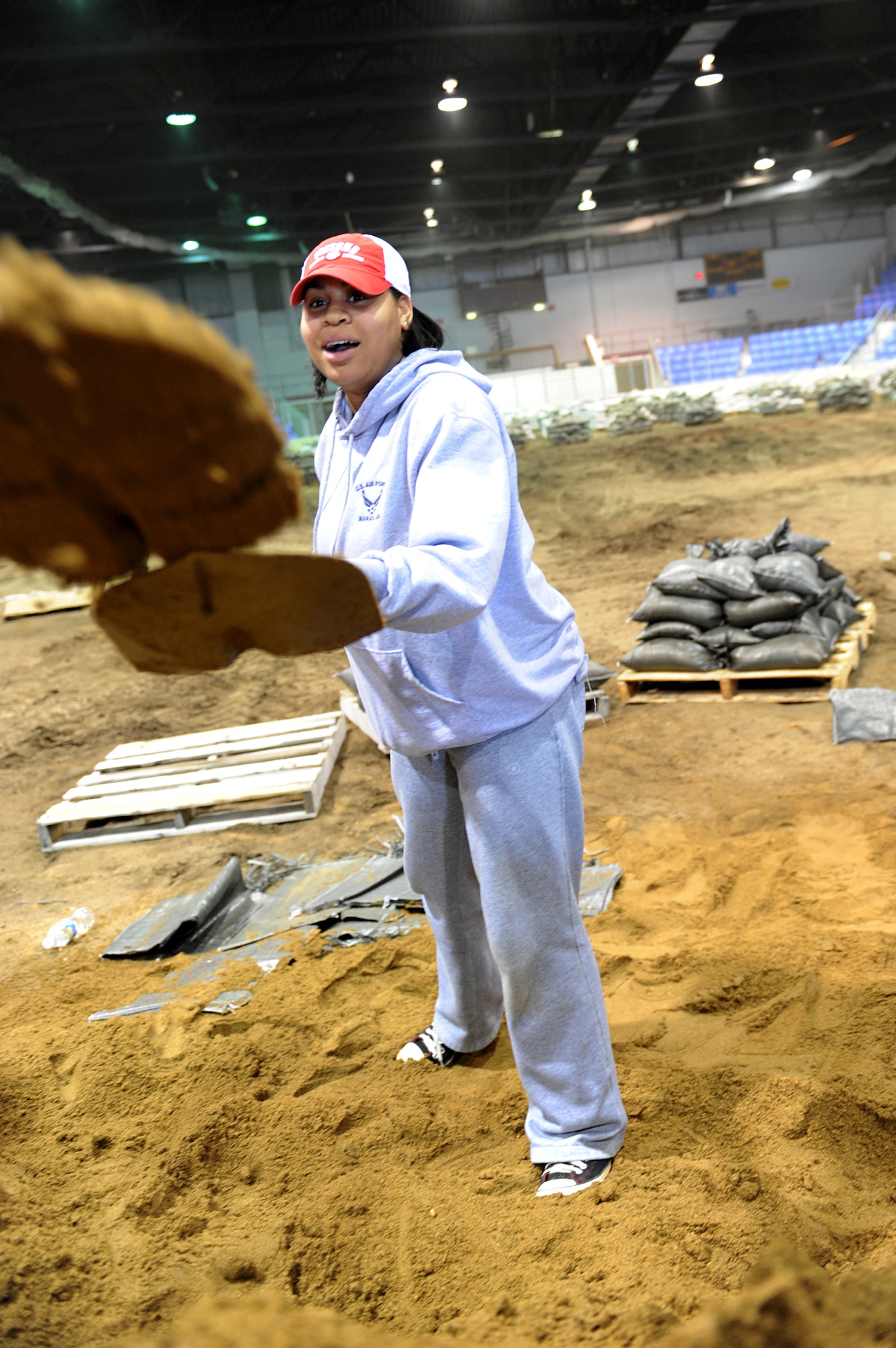 MINOT, N.D. – Senior Airman Sharida Jackson, 5th Bomb Wing Public Affairs photographer, spends her afternoon helping fill sand bags to aid in flood relief efforts, April1. Minot area volunteers from the community and Minot Air Force Base reached their goal of filling 25,000 sandbags in the first two days alone. Minot AFB has been in the thick of the fight with flood efforts the past few weeks, whether it be augmenting support forces at Grand Forks AFB, N.D., or sending helicopters and rescue equipment to Fargo or Bismarck, N.D.  (U.S. Air Force photo by Senior Airman Kelly Timney)