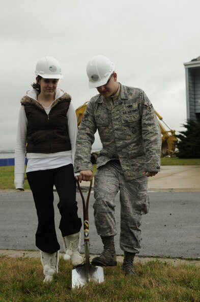 Airman 1st Class Coby Poe and his wife, Holly, residents of Bolling Housing, dig up a patch of earth at the BLB Privatized Housing groundbreaking ceremony April 3 in the old Rickenbacker South neighborhood. The ceremony was held to commence the demolition of old homes and the construction of new homes there. (U.S. Air Force photo by Staff Sgt. Raymond Mills)