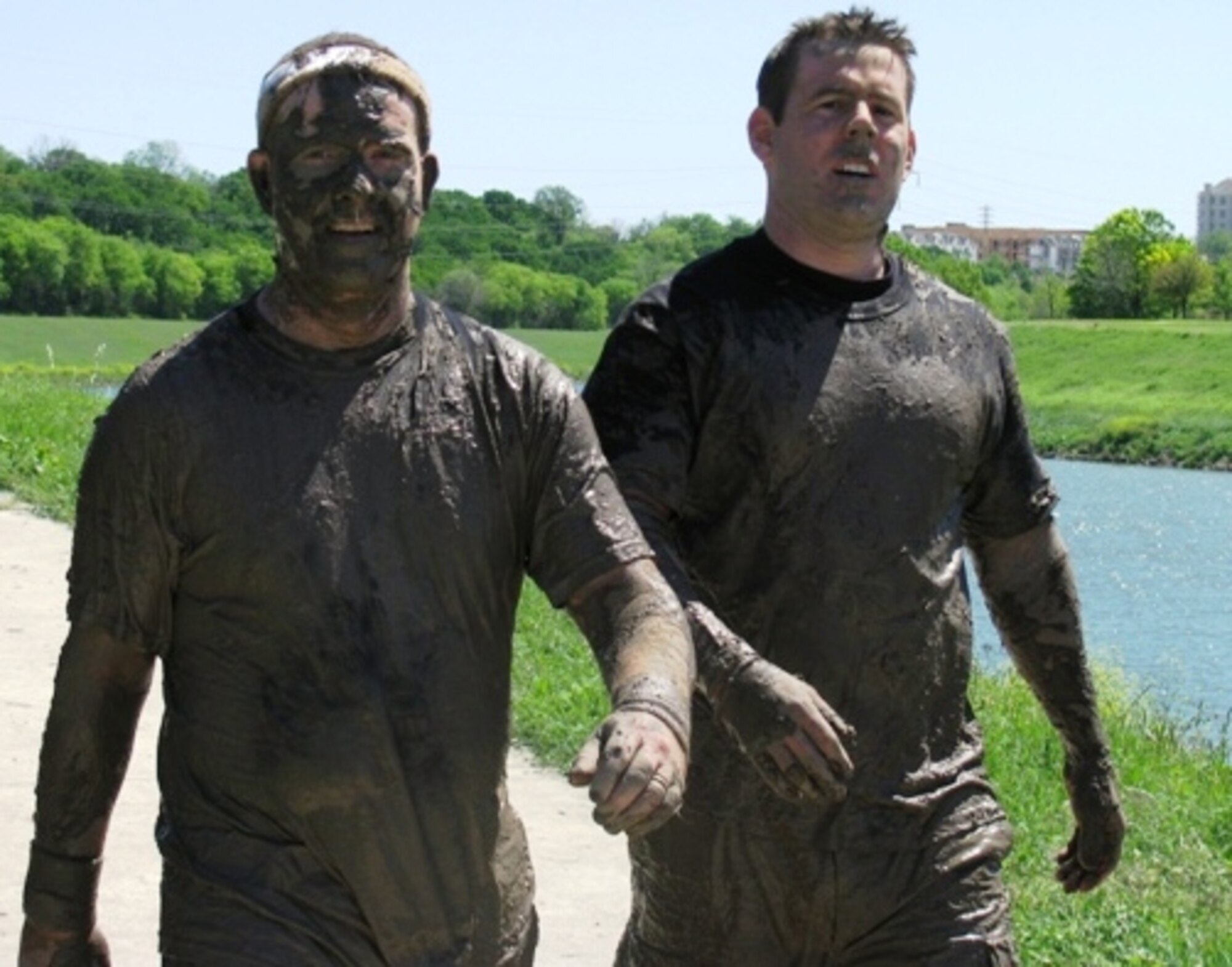 Lt. Col. Sean McKenna (left) and Staff Sgt. Jason Thornhill catch their breath after crossing the finish at the 10K Dallas-Fort Worth Mud Run March 29. The team finished the race in 1 hour and 55 minutes and raised money for local charities. (U.S. Air Force photo/Master Sgt. Jim Rumer)