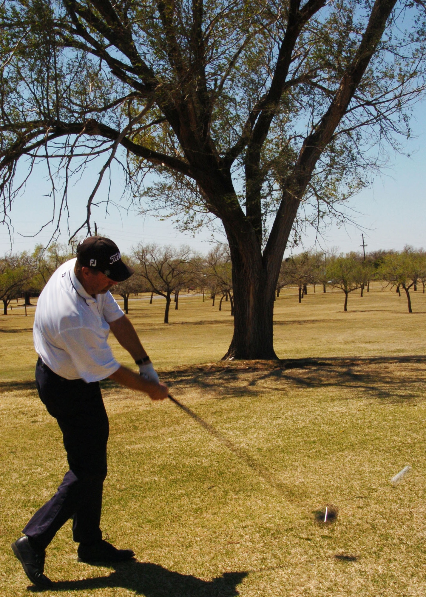 ALTUS AIR FORCE BASE, Okla. -- Rusty Wortham, Windy Trails Golf Course manager, tees off at the first hole of the course April 6. Windy Trails offers a variety of services to a gamut of people with different skill levels ranging from beginner and intermediate golf clinics to golf gear rental and purchase. (U.S. Air Force photo by Airman 1st Class Tiffany M. Deuel)