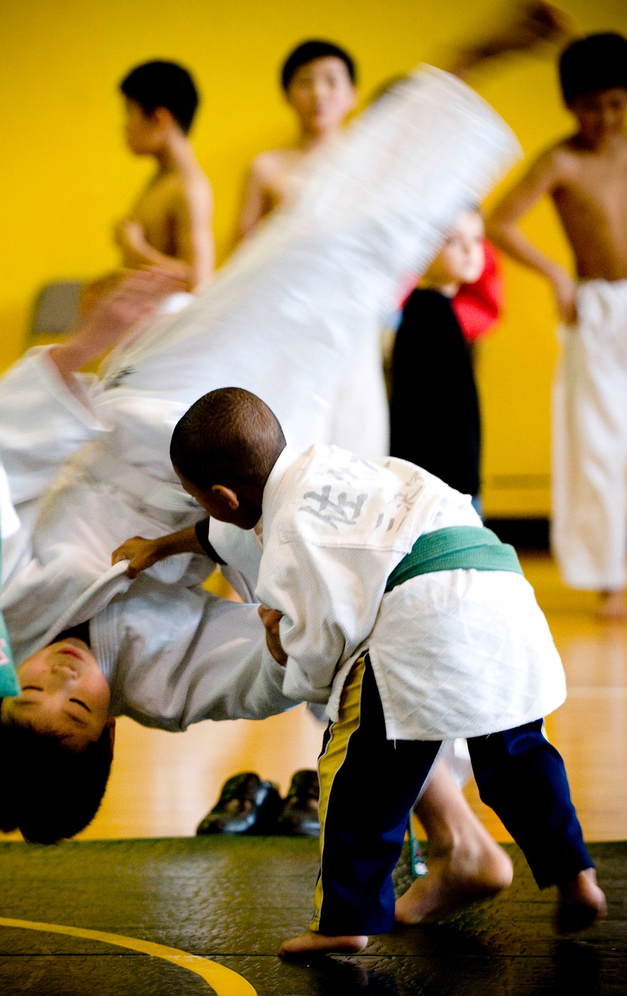 MISAWA AIR BASE, Japan -- Isaiah Erby throws a Japanese judo student during Japan Day April 4, 2009. The local judo school performed a demonstration for the audience and then gave spectators a chance to learn a few moves. (U.S. Air Force photo by Staff Sgt. Samuel Morse)