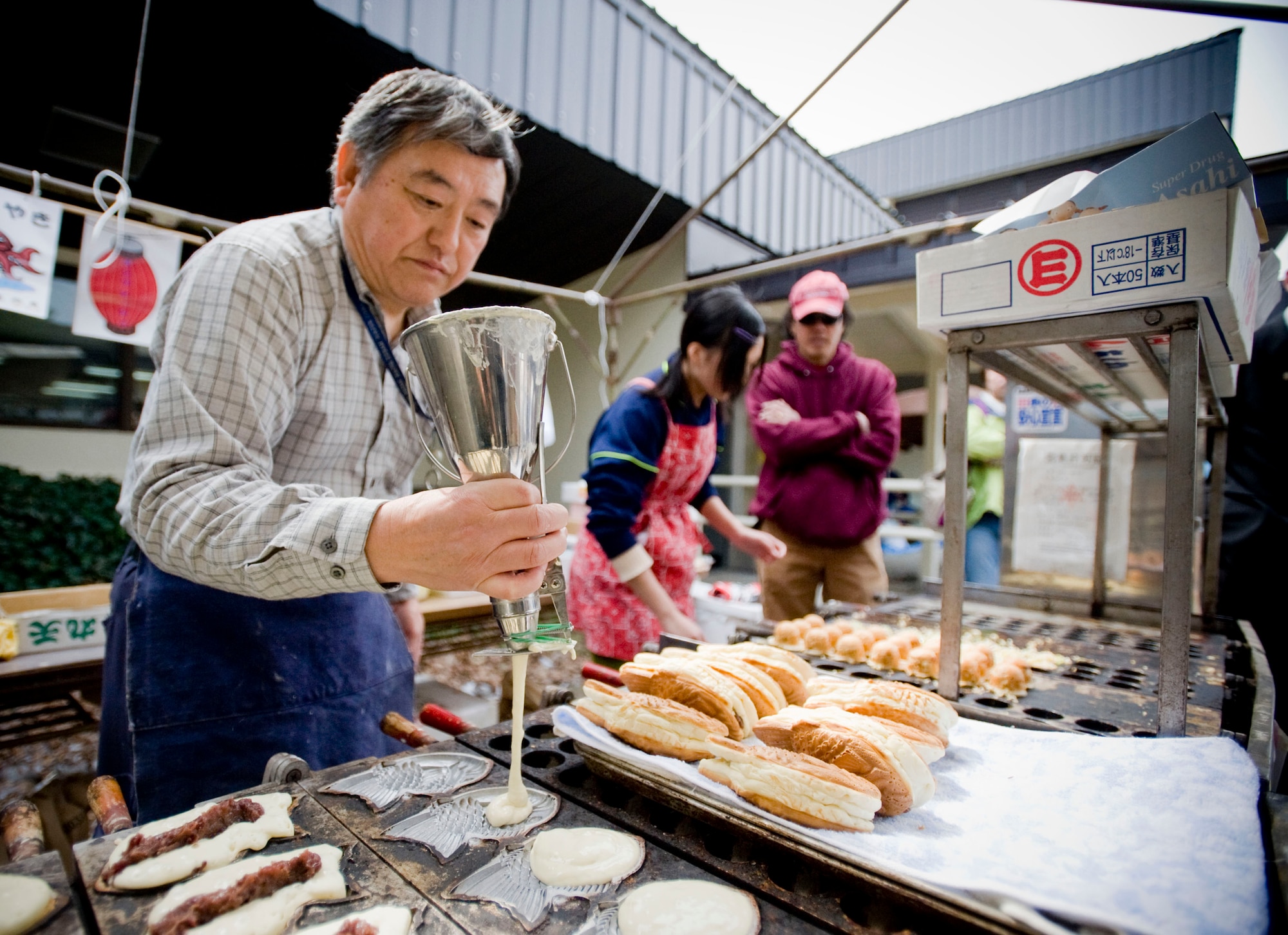 MISAWA AIR BASE, Japan -- Hiroshi Yamamoto makes taiyaki, a pastry filled with sweet red bean paste, during Japan Day April 4, 2009. In addition to the demonstrations, musical performances and cultural exhibitions, food vendors provided a taste of Japan through their culinary skills. (U.S. Air Force photo by Staff Sgt. Samuel Morse)