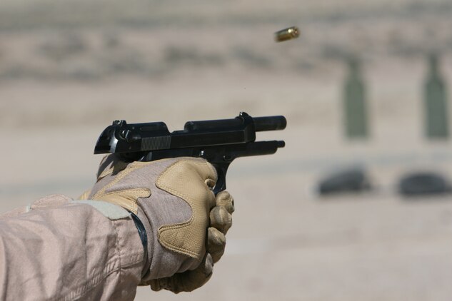 A bullet casing ejects from an M9 pistol after a Marine with a company from 2d Marine Special Operations Battalion, U.S. Marine Corps Forces, Special Operations Command fires at his target. The Marines and Sailors conducted shooting drills as part of their Dynamic Assault package at the Washoe County Regional Shooting Facility here, April 7.