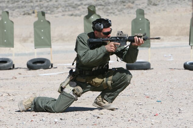 A Marine with a company from 2d Marine Special Operations Battalion, U.S. Marine Corps Forces, Special Operations Command demonstrates shooting positions to fellow Marines and Sailors prior to conducting shooting drills as part of their Dynamic Assault package at the Washoe County Regional Shooting Facility here, April 7.