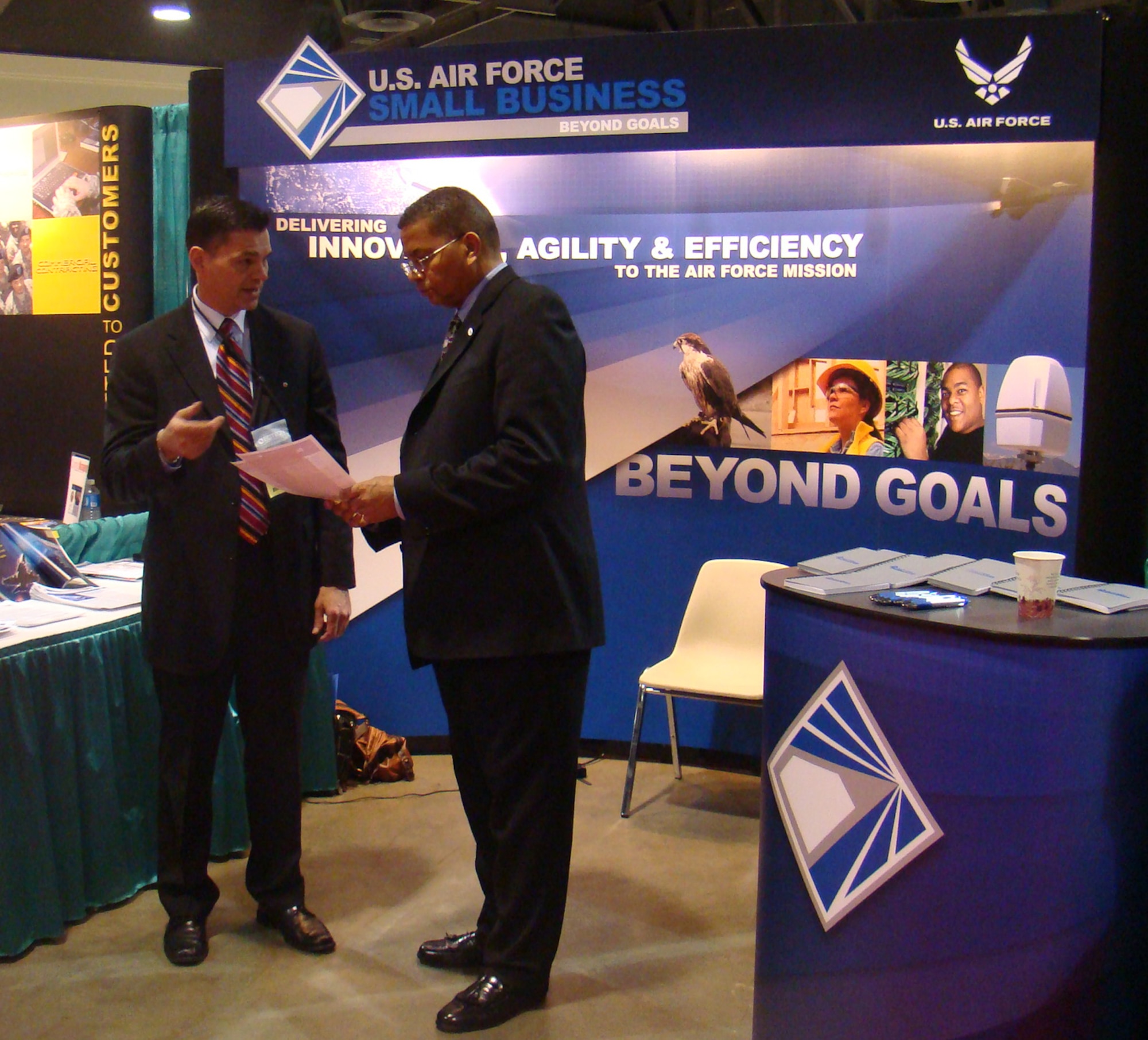 Tim Douglas of the Air Force Office of Small Business Programs (left) speaks with Frank Anderson, president of Defense Acquisition University, at the Air Force Small Business exhibit during the National Contracting Management Association World Congress in Long Beach, Calif., April 5 to 8. (Courtesy photo)
