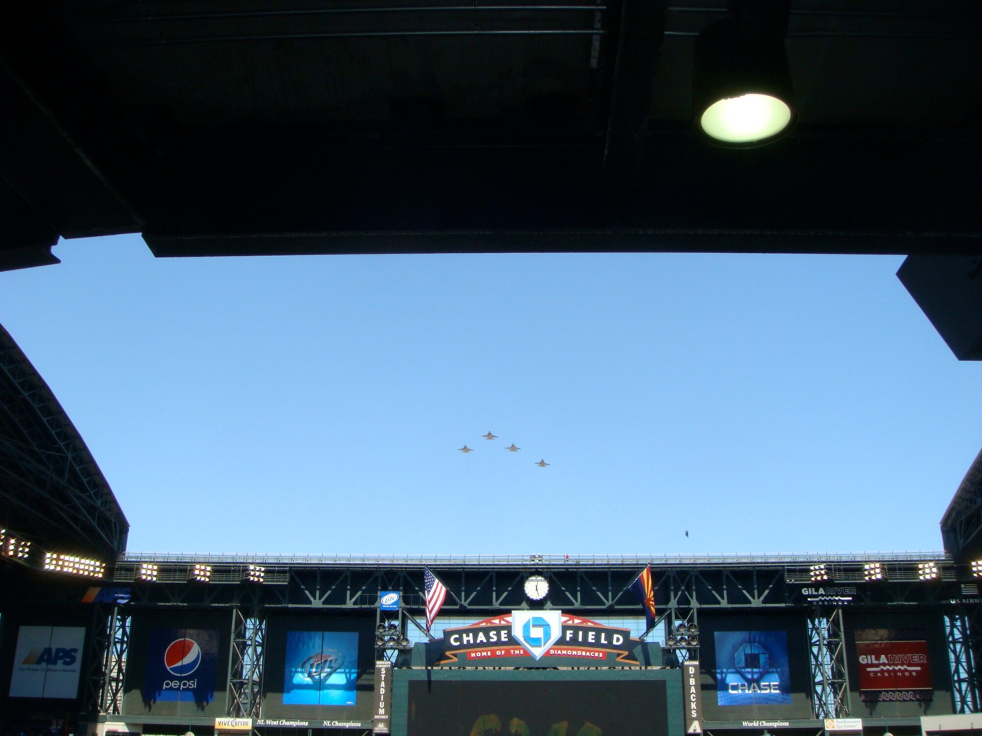 A formation of F-16 Fighting Falcons from the 61st Fighter Squadron, "Top Dogs," out of Luke Air Force Base approach  Arizona Diamondbacks Chase Field as part of a flyover in support of baseball opening day festivities in Phoenix April 6. (U.S. Air Force photo/Rusty Mitchell)

