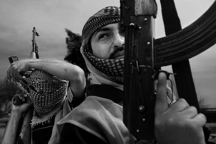 Master Sgt. Andrew Dunaway was awarded the honor of Photograph of the Year for the Visual Information Awards Program for his photo of the Sons of Iraq preparing to secure a torture house for destruction in Iraq. He is assigned to the 1st Combat Camera Squadron. (U.S. Air Force photo/ Master Sgt. Andrew Dunaway)
