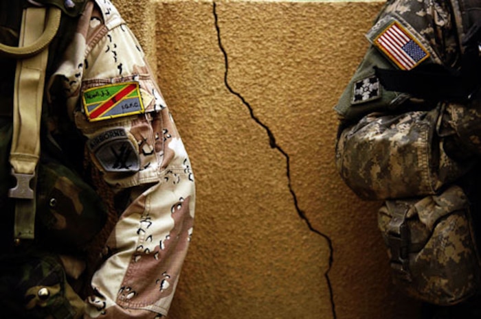 Staff Sgt. Manuel Martinez took first place in the Illustrative Photography category for his photo of a U.S. Army Soldier and a Iraqi Army Solider standing against a wall in Iraq. Sergeant Martinez is with the 1st Combat Camera Squadron. (U.S. Air Force photo/Staff Sgt. Manuel Martinez)