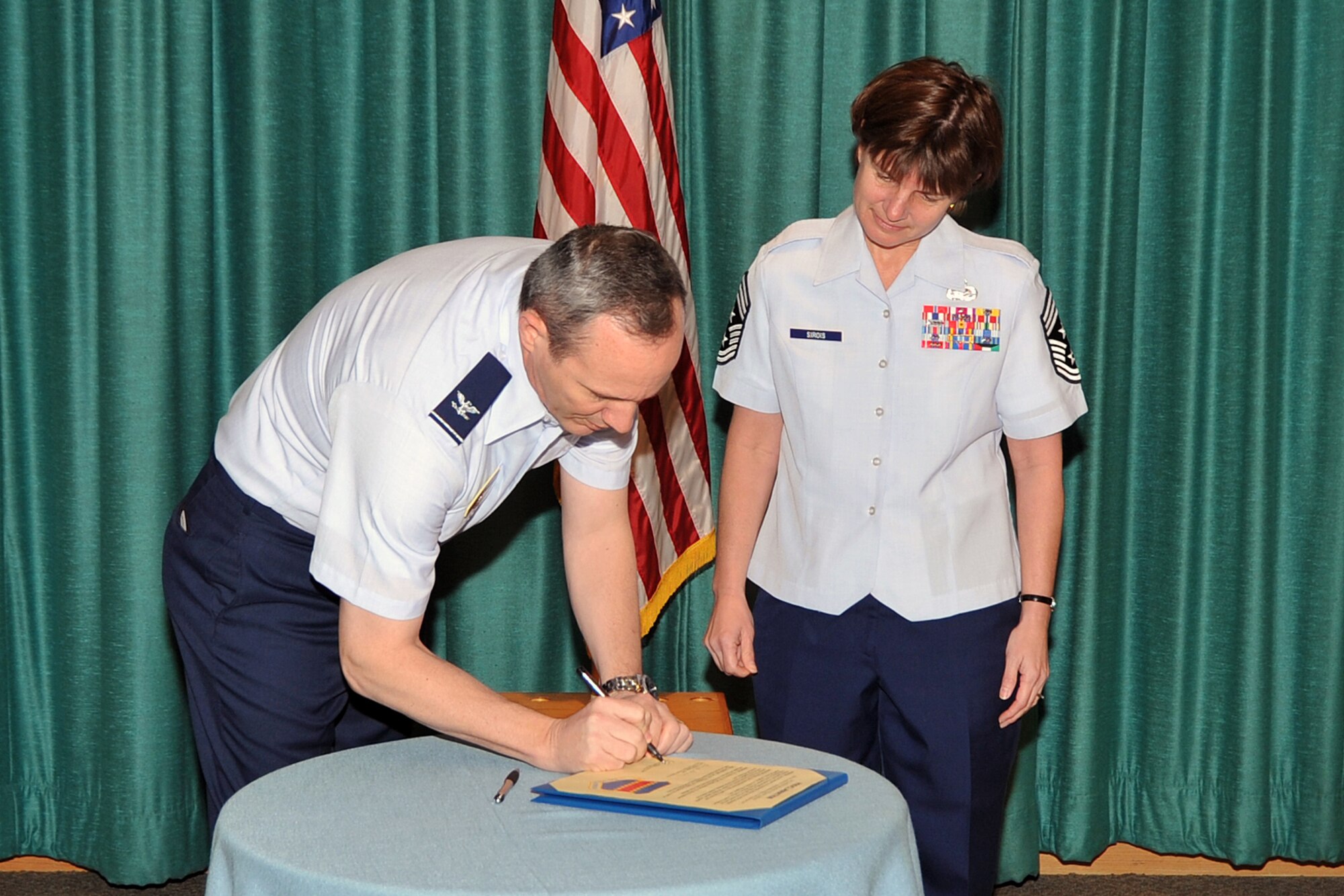 Col. Robert L. Maness, 55th Wing vice commander and Chief Master Sgt. Lisa A. Sirois, 55th Wing command chief master sergeant sign a proclamation declaring April, sexual assault prevention month April 6 at the Daugherty Conference Center. The proclamation aims to promote a base-wide Wingman culture and reduce the number of sexaul assault cases. 
U.S. Air Force photo by Jeff Gates