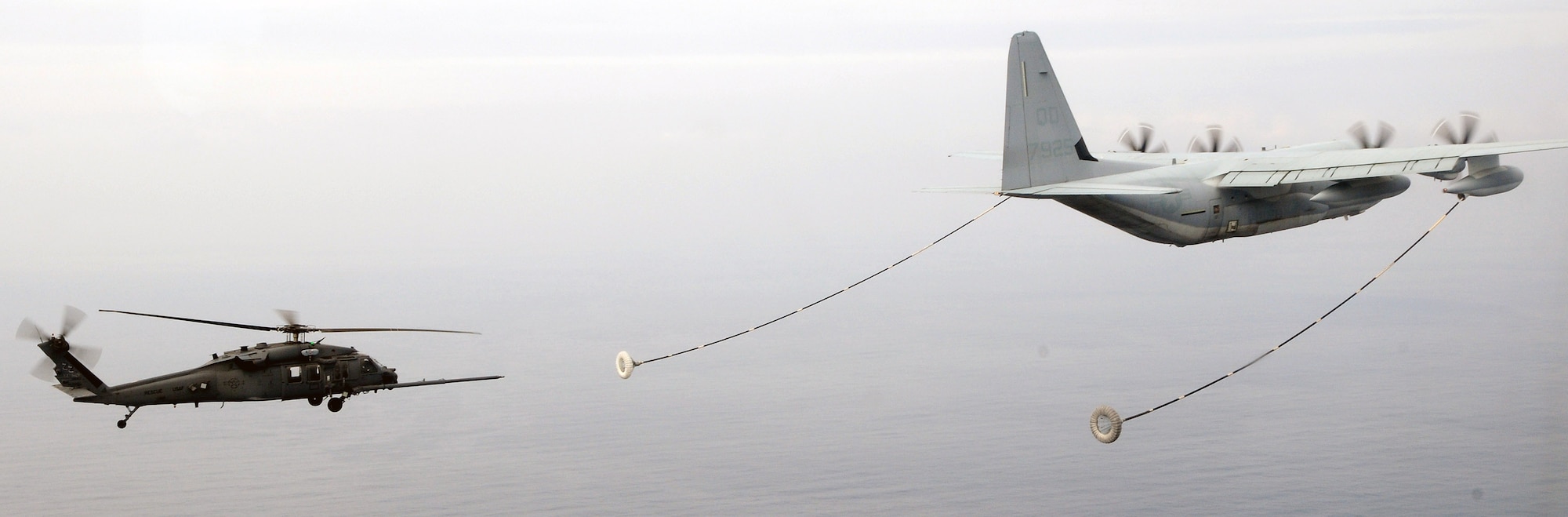 An HH-60G-Pave Hawk from the 33rd Rescue Squadron receives fuel from an MC-130 during a three-day intensive air refueling course March 24 at Kadena Air Base, Japan. Pilots from the 33rd RQS put together a refueling training program for Japanese Self Defense Force helicopter pilots to provide them the tools to begin conducting long-range rescue missions. (U.S. Air Force photo/Staff Sgt. Chrissy Best) 
