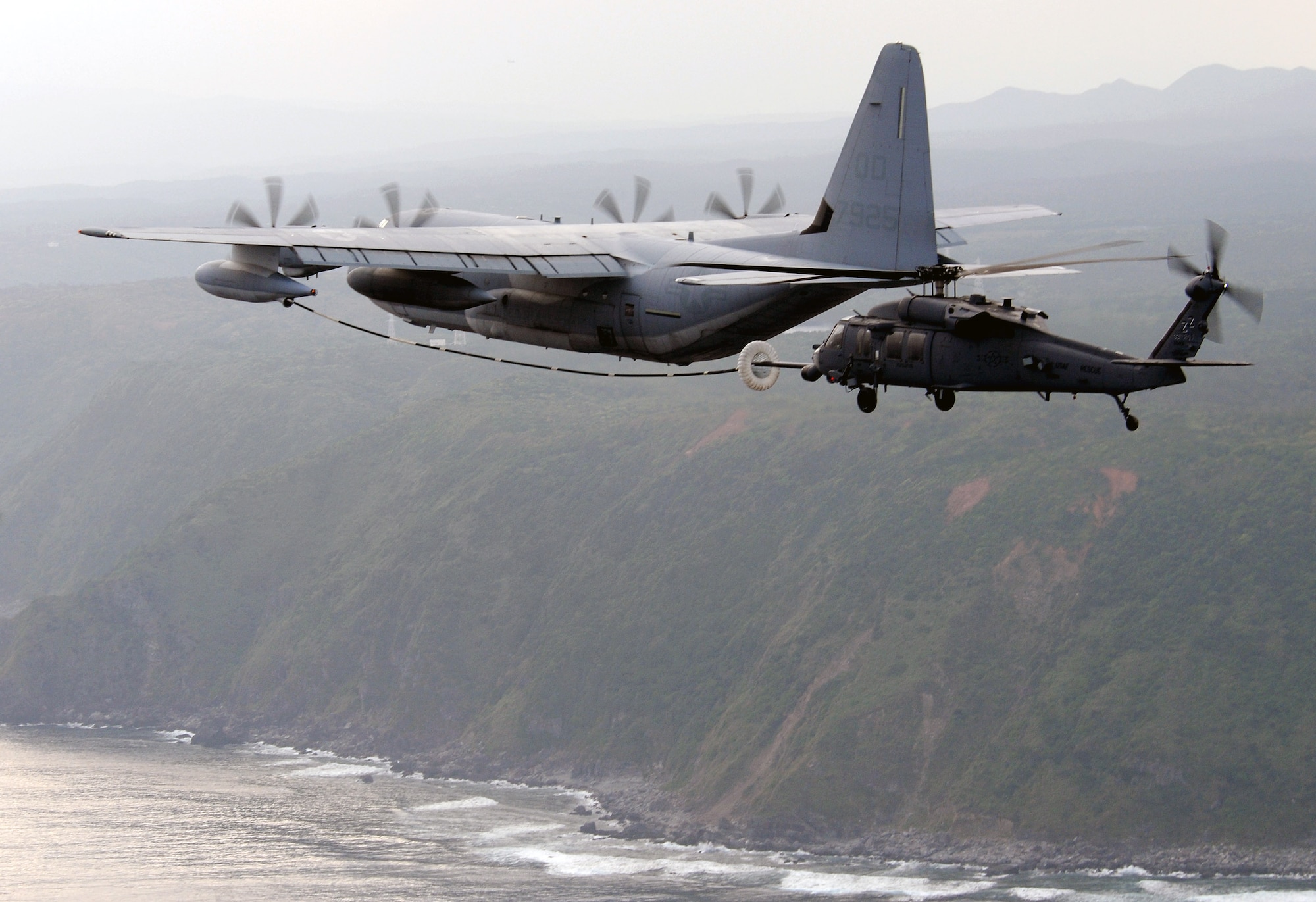 An HH-60G-Pave Hawk from the 33rd Rescue Squadron receives fuel from an MC-130 during a three-day intensive air refueling course March 24 at Kadena Air Base, Japan. Pilots from the 33rd RQS put together a refueling training program for Japanese Self Defense Force helicopter pilots to provide them the tools to begin conducting long-range rescue missions. (U.S. Air Force photo/Staff Sgt. Chrissy Best) 
