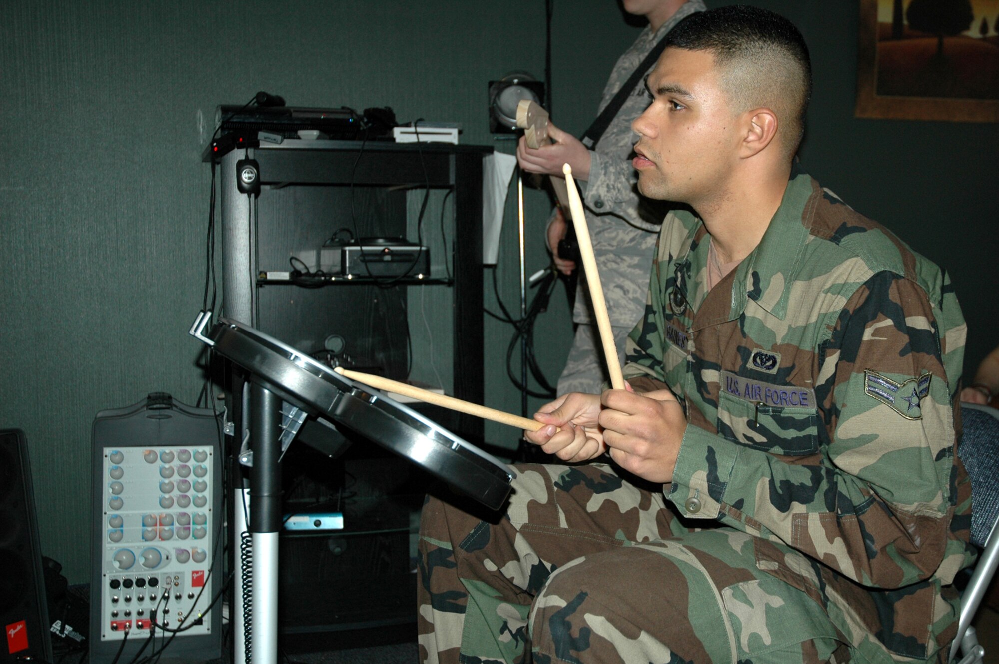 Airman 1st Class David Gaines, 341st Civil Engineer Squadron heating, ventilation and air conditioning technician, plays drums at the Detour Airmen's center April 2, following it's renovation and ribbon-cutting ceremony. (U.S. Air Force photo/Senior Airman Dillon White)