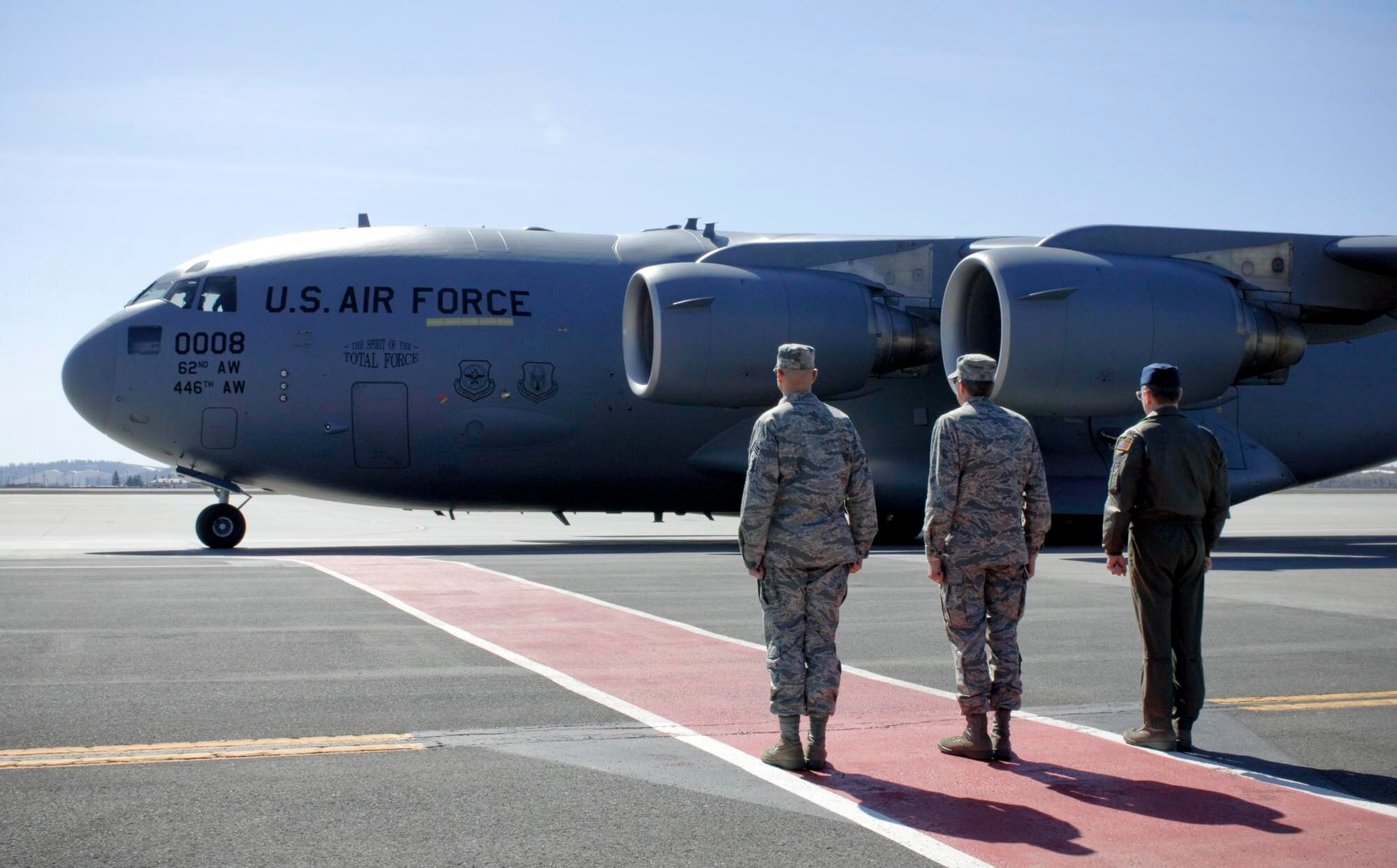 Col Robert Thomas, 141st Air Refueling Wing commander Col Greg Burkley, and command chief, Chief Master Sgt. David Nordel waits the arrival of the civic leaders’ tour from McChord Air Force Base April 7. (U.S. Air Force photo / Airman 1st Class Darlene West)
