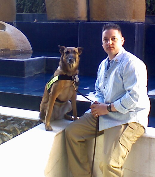 Staff Sgt. John Johnson, 341st Security Forces Squadron military working dog handler, and Bibi, Belgian Malinois bomb dog, pause for a photo opportunity in Santiago, Chile, where the team was on temporary duty assignment with the United States Secret Service in support of a vice presidential visit March 25 to 30. (Courtesy photo)