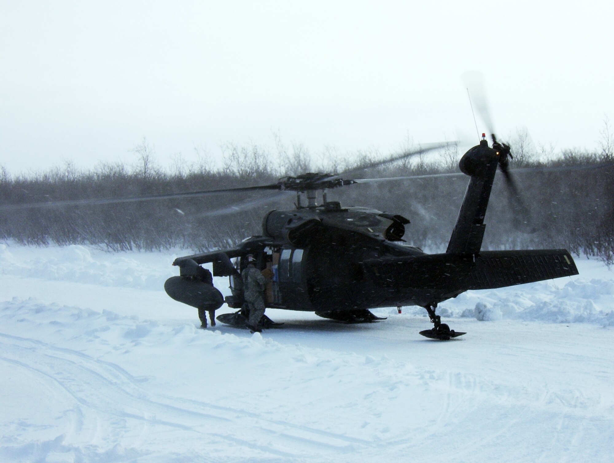 A U.S. Army Black Hawk helicopter sits parked just long enough to unload supplies outside the front of a school in Alakanuk, Alaska, one of 11 villages visited by U.S. military medical personnel in March during Operation Arctic Care. (Courtesy photo)
